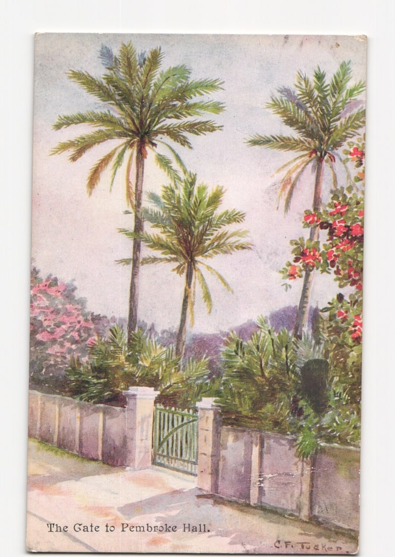Illustrated postcard showing 'The Gate to Pembroke Hall' with palm trees, Bermuda, early 20th: A vibrant chromolithograph illustrates 'The Gate to Pembroke Hall,' featuring a light-colored stone wall and a green gate in the foreground. Three tall palm trees dominate the upper half of the vertic