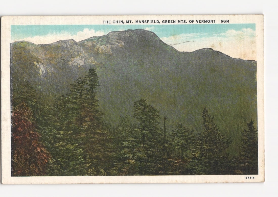 Scenic view of The Chin, Mount Mansfield, Green Mountains of Vermont c.1941 colorized postcard: A horizontal colorized view postcard depicting The Chin, Mount Mansfield, in the Green Mountains of Vermont. The image is dominated by heavily forested mountain slopes, rising towards a rugged, rocky 
