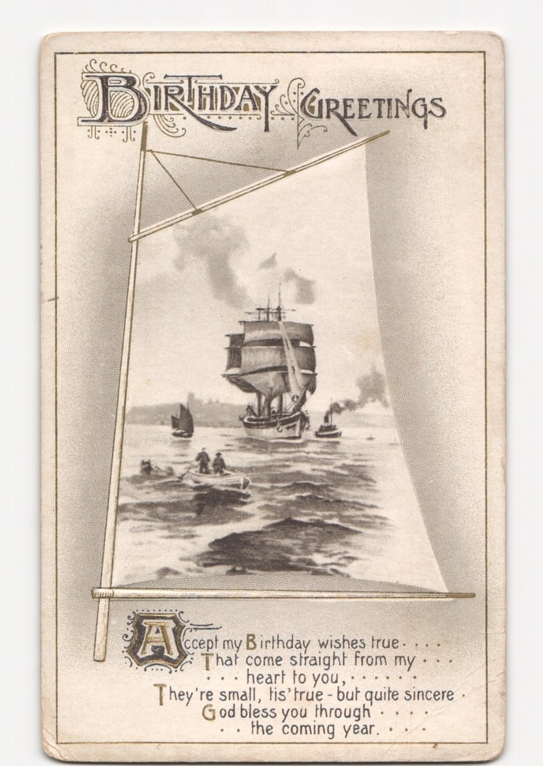 Early 20th Century Illustrated Birthday Greetings Postcard with Large Sailing Ship at Sea: A large sailing ship, possibly a steam-sail hybrid, is depicted on a body of water, emitting smoke from a stack. Smaller boats with figures are present in the foreground. The scene is framed by a styl