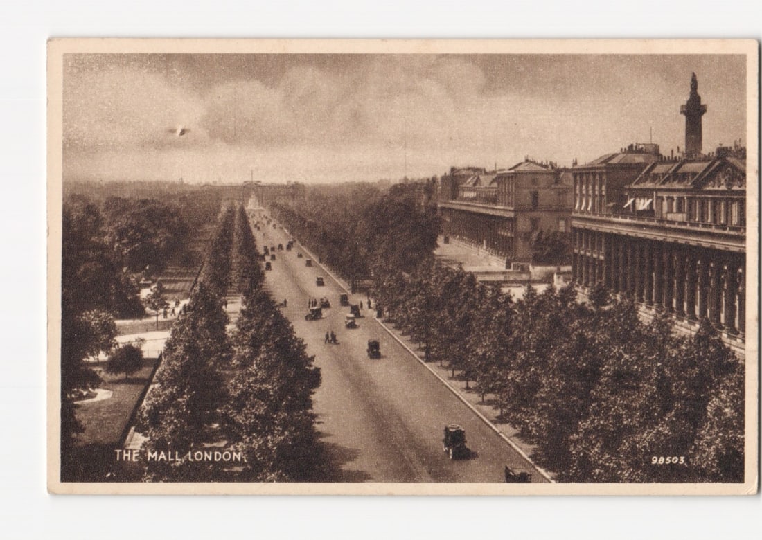 The Mall, London, Grand Avenue with Early Automobiles and Architecture, Sepia-Toned Postcard: A sepia-toned photograph depicts The Mall in London, a wide, tree-lined avenue, from an elevated perspective looking toward a distant arch. Early model automobiles and pedestrians are visible on the r