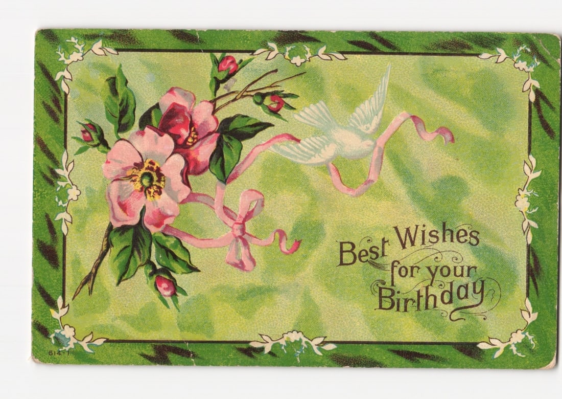 Early 20th Century Chromolithograph Birthday Wishes Postcard with Flowers and Dove: A chromolithograph postcard features a central illustration of pink roses with green leaves and buds, alongside a white dove or bird with a long pink ribbon flowing from its beak. The bird flies towar