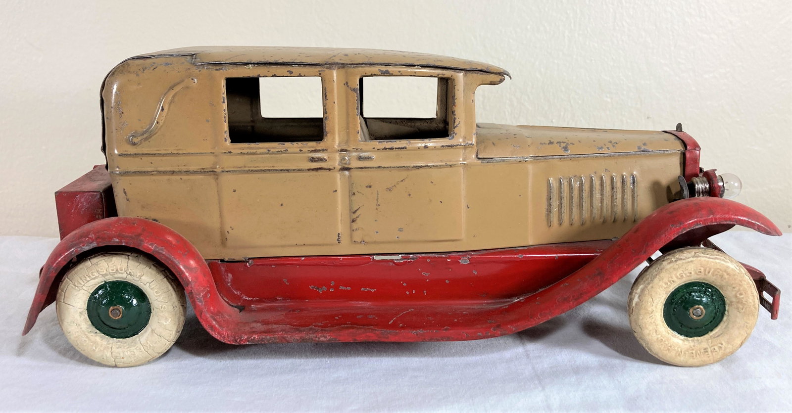 Kingsbury 1920s Brougham 4 Door Sedan #245 Deluxe Lighted Pressed Steel Toy Car: This is a wonderful original toy in good condition. It shows consistent wear overall. Appears to have original tires (with crazing) and original paint. There is noticeable wear to the paint. This is t