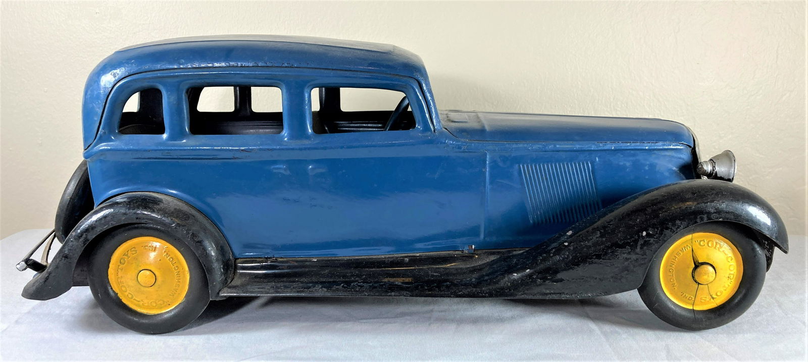 Cor-Cor Graham Large Scale Pressed Steel Sedan Toy Car w/ Electric Headlights: This is a very nice period original toy. Tires and paint appear to be mostly original. There is wear to the finishes consistent with playwear throughout. Tires show age. Front passenger tire is cracke