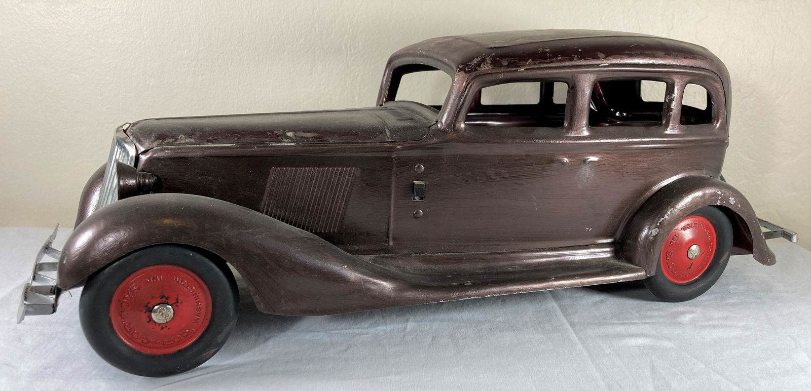 Cor-Cor Graham Large Scale Pressed Steel Sedan Toy Car w/ Electric Headlights: This is a very nice period original toy. Tires appear to be original. There is wear to the finishes particularly on the roof. Paint shows brush strokes in places and may not be original. No steering w