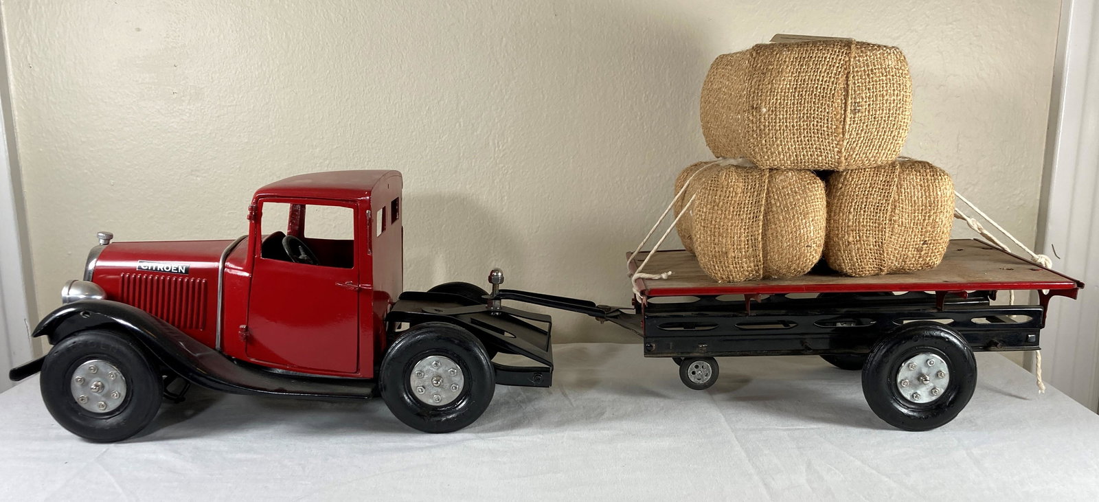 Les Jouets Andre Citroen C-4 Tractor Trailer Flat Bed Tin Tinplate Toy Truck: This is a tough to find early tin toy. It has been displayed with cotton bundles as shown that are likely contemporary. The paint on the vehicle also appear contemporary. Tires may or may not be origi