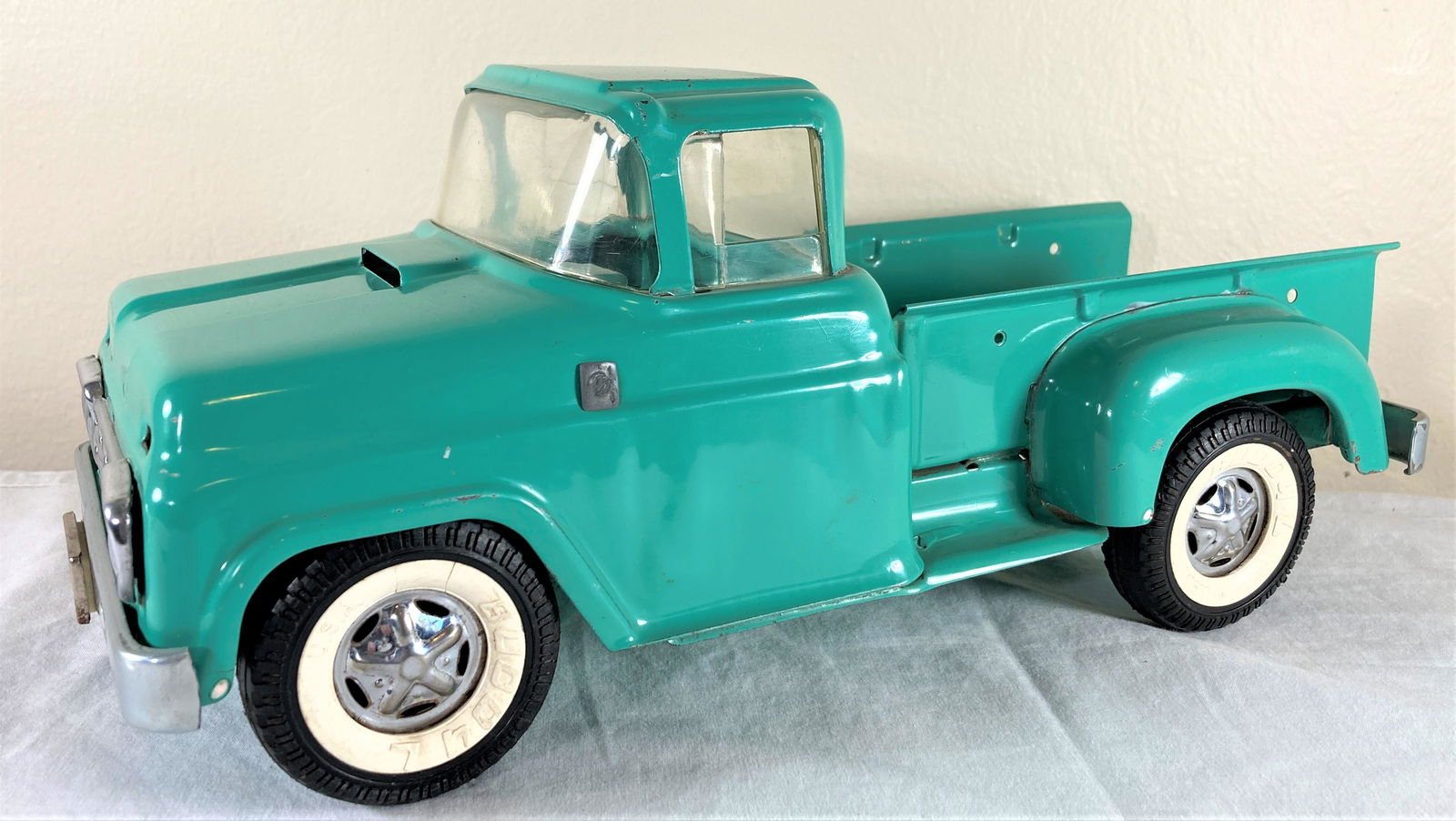 Buddy L Pressed Steel Turquois Toy Pick-Up Truck: Wonderful original pickup truck in great condition. Minor play wear. Some dust from display. The driver side mirror seems to be missing. Approximately 10 inches long.