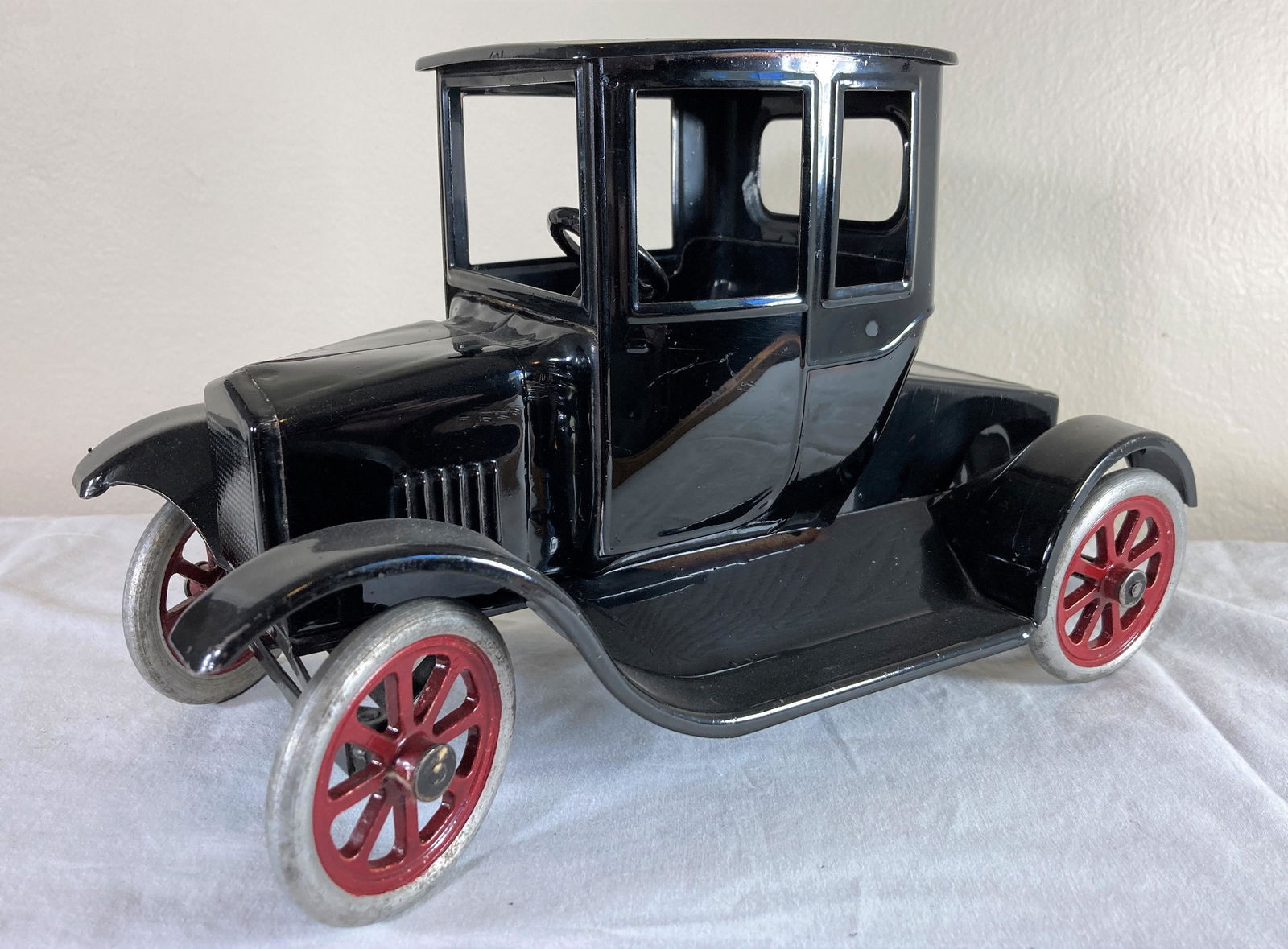 Buddy L Fliver Model T Ford Tin Lizzie Pressed Steel Toy Car: This is a wonderful toy in very good condition. It shows minor wear overall. Some dust present from display. Appears to have been professionally restored to its former glory. Excellent workmanship. Me