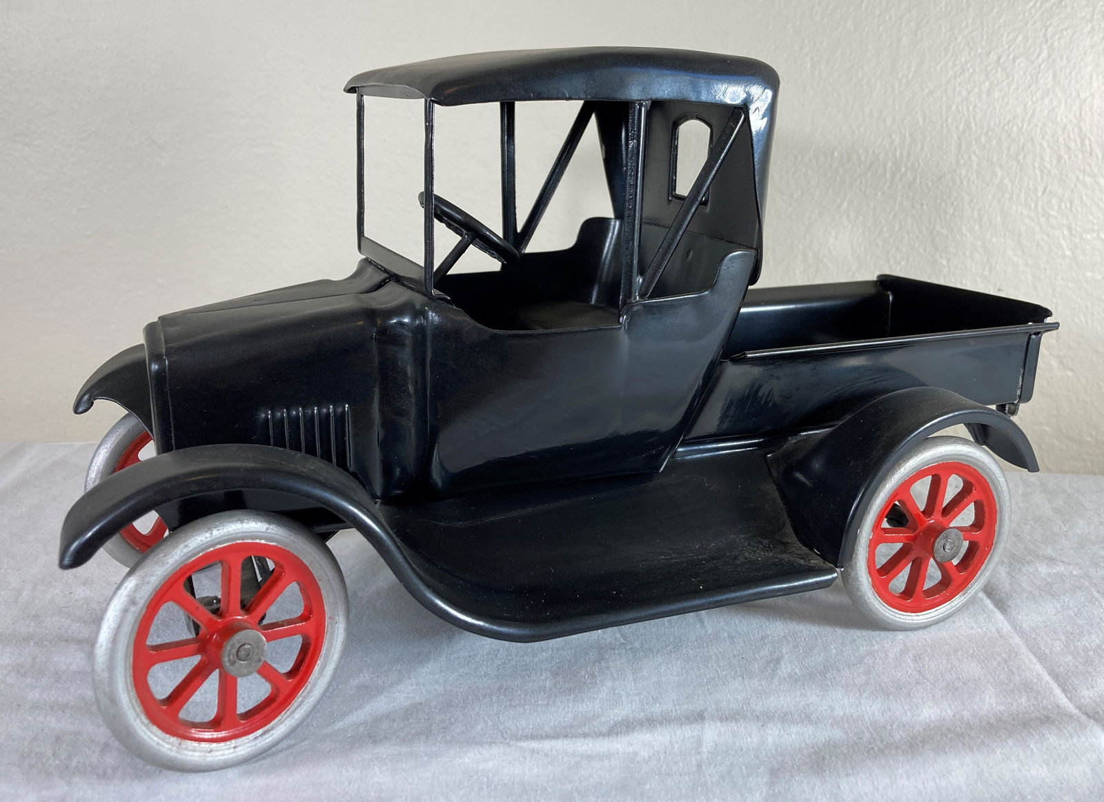 Buddy L Fliver Model T Ford Tin Lizzie Pressed Steel Toy Truck: This is a wonderful toy in very good condition. It shows minor wear overall. Some dust present from display. Appears to have been professionally restored to its former glory. Excellent workmanship. Me