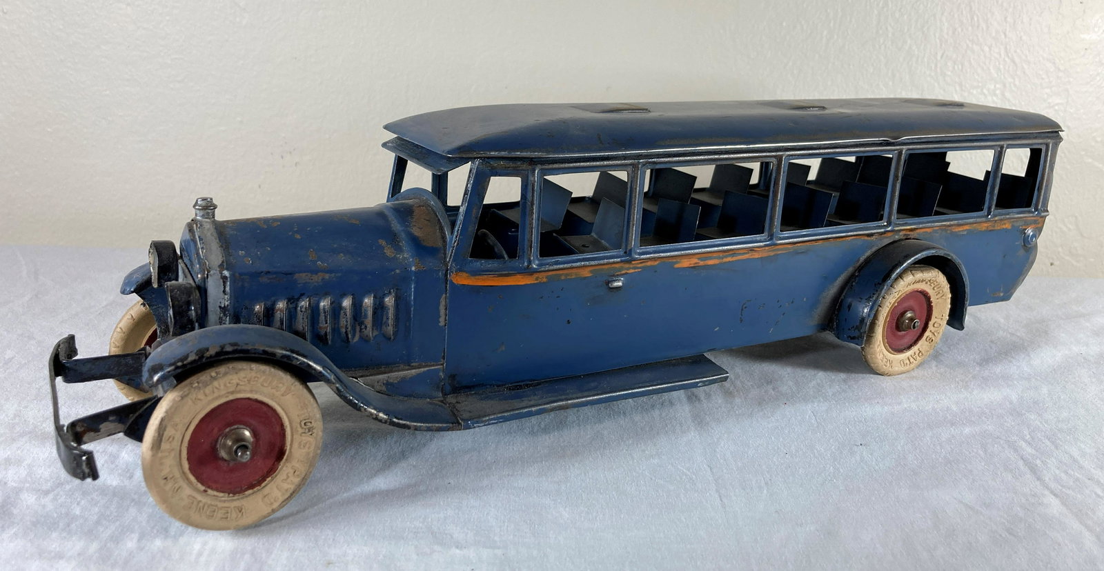 Kingsbury Pressed Steel 788 Clockwork Bus Toy Vehicle: This is a wonderful toy in very good condition. It shows minor wear overall. Some dust present from display. Appears to original finish. Original tires show crazing. Mechanism works. Approximately 15