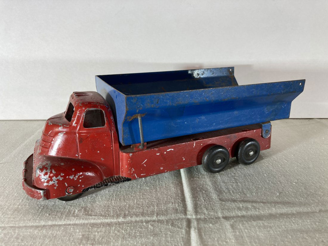 Slik Toys Cast & Steel Dump Truck: This is a very nice original piece. It shows some play wear, but is still very nice overall.