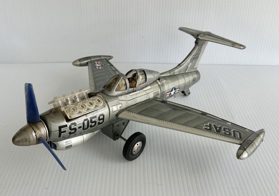 Vintage 13" 1950s Nomura FS-058 USAF Battery Op Tin Toy Airplane: This is a Vintage 1950s Japan Nomura FS-058 USAF Battery Op Tin Toy Airplane. Measures 13 inches. Appears to have some silver touch up on bottom rear fuselage...Nice Working Condition.