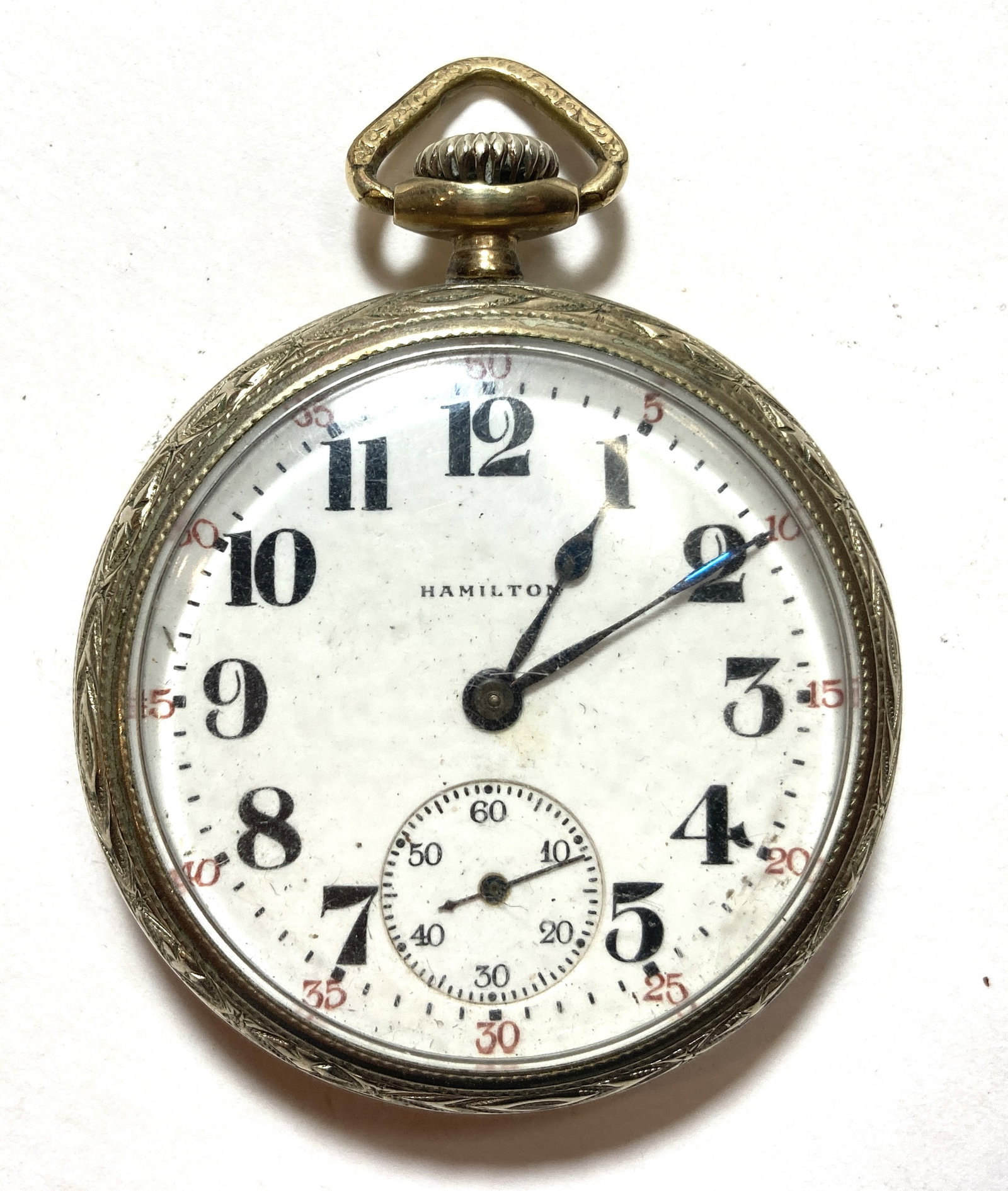 Hamilton Watch Co Railroad Conductor Pocket Watch Model 974 17 Jewel: This is a really nice vintage piece in very good condition. The case is 10kt gold filled. Runs for a bit and slows and stops. Needs to be serviced. Diameter without the stem is approx 1 7/8 inches.