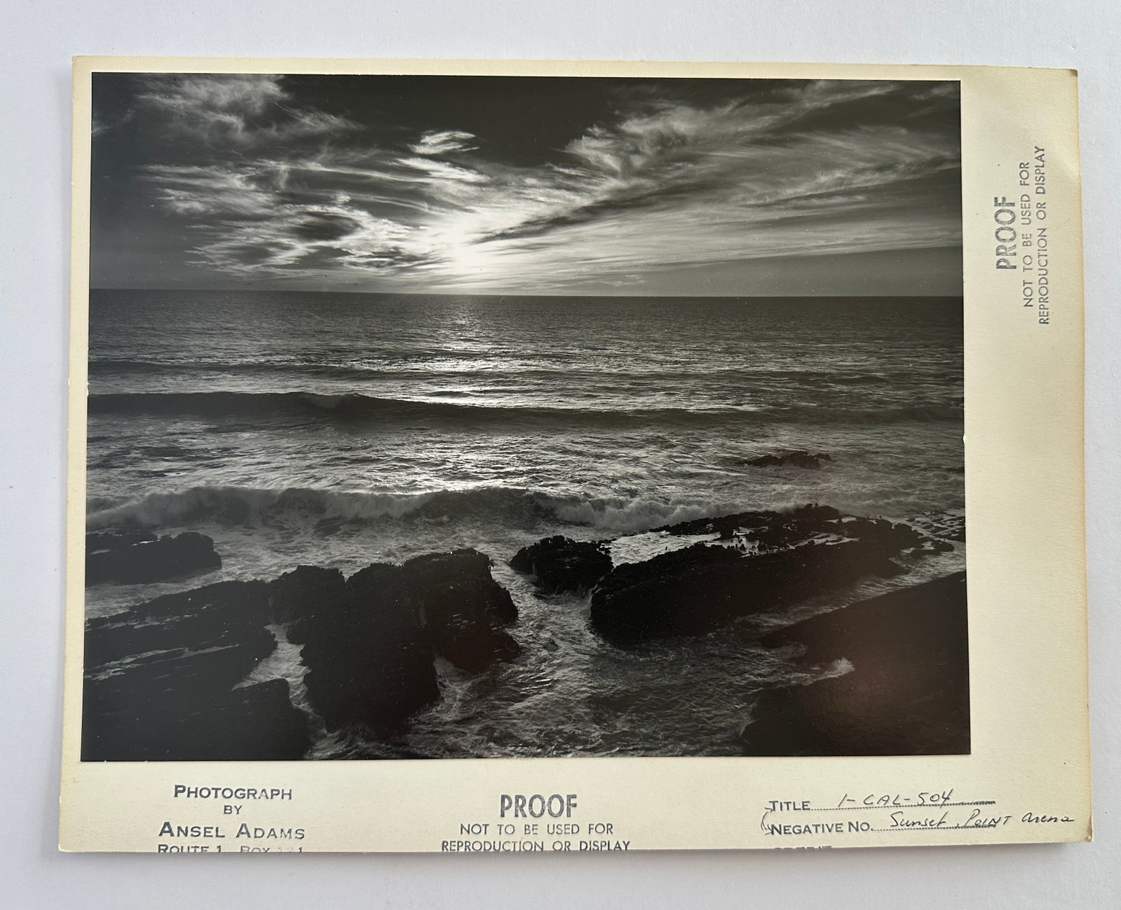 Original Ansel Adams Photo Proof Point Arena California Sunset: This is an Original Ansel Adams Photo Proof Point Arena California Sunset. It measures overall 11 x 8 1/2 with the image measuring 9 1/2 x 7 1/4 inches. It has the stamped markings of a proof with the