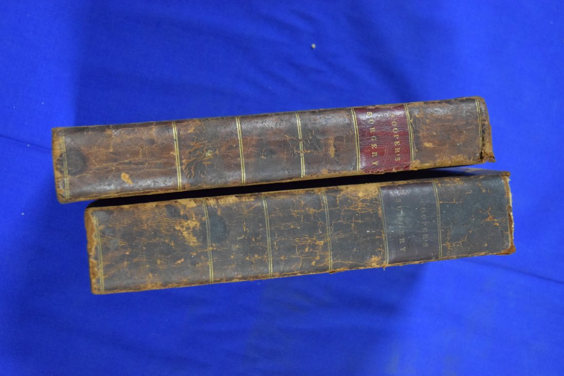 Lot of 2 Coopers Surgery Volumes 1 and 2-1822: By Samuel Cooper with notes by Alexander H. Stevens, M.D. Published by James V. Seaman. Leather bound. Binding and spline intact. No rips or tears. Some black and white plates. Foxing in places. 5 1/2