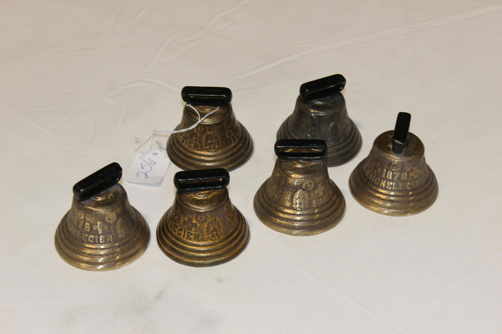 six brass bells marked 1878 Saicnelecier (1 of 9)