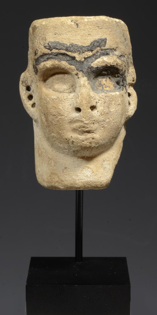 Fine Mesopotamian Frit Face Inlay: Circa Middle to Late Elamite Period circa 1500-1100 BC. A tan frit composition head, as a relief attachment, holes drilled at ears. The surface with mineral deposits and areas recessed for additional 