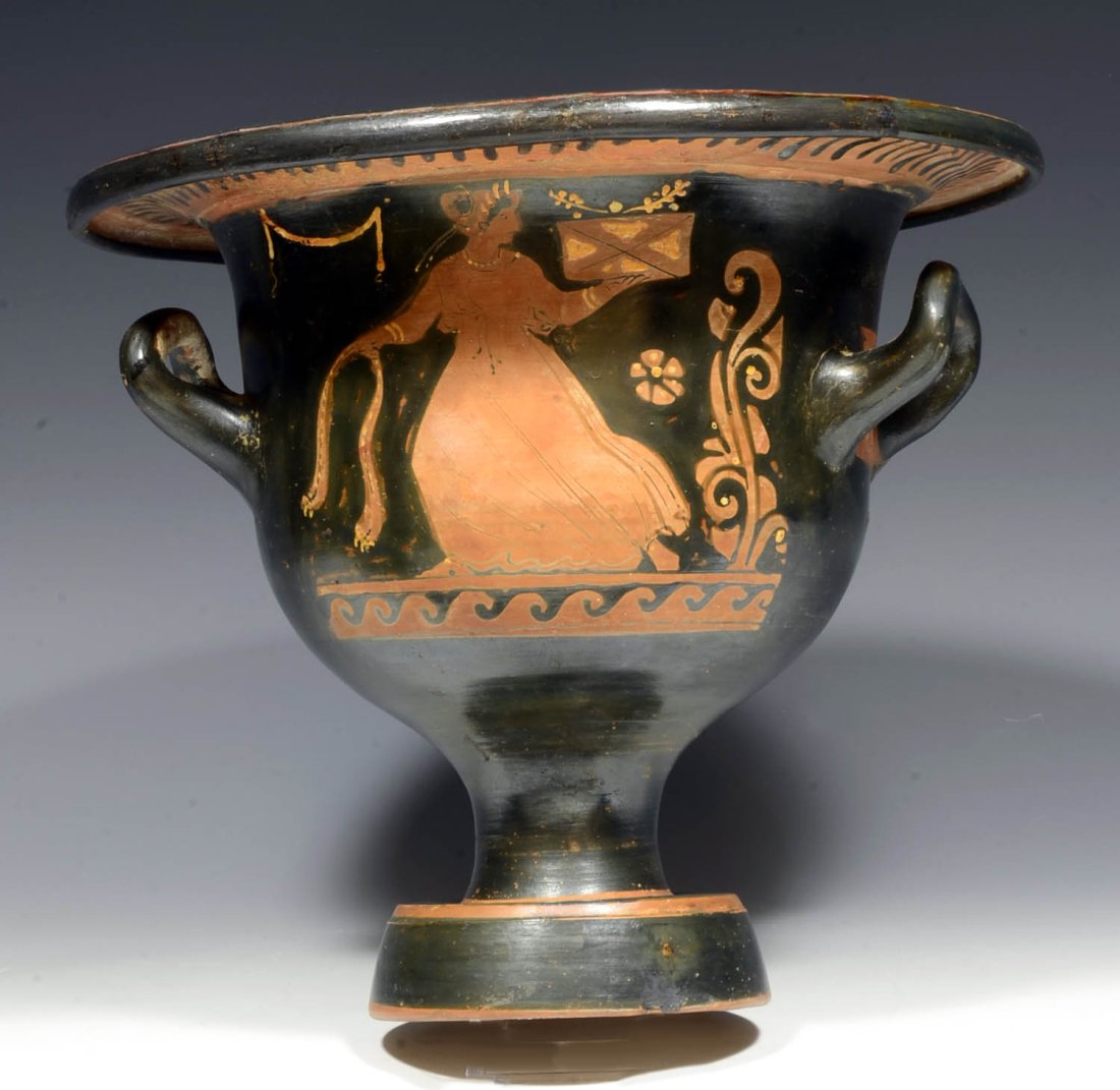 Apulian Red Figured Bell Krater Attributed to Chevron Group Published Trendall & Sotheby's: Circa 4th century BC.An inverted ceramic bell shape with twin handles under the rim and used in the symposium as a wine and water mixing vessel. Decorated with added white and ochre slip in the red fi