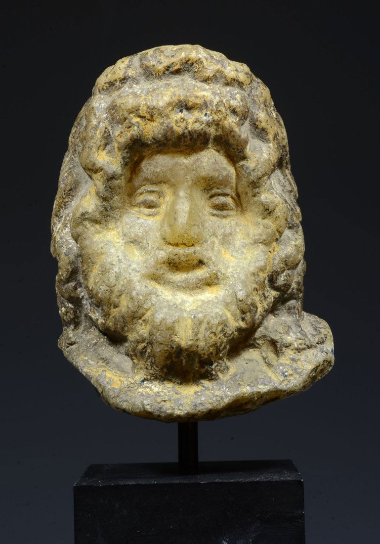 Roman Alabaster Bust of Zeus Serapis: Roman Imperial, Ca. 2nd Century AD. Based on a Hellenistic prototype of the 2nd Century BC., his face with deep-set eyes, and unruly beard of deeply drilled curls, his long wavy hair bound in a diadem