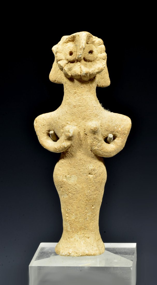 Early North Syrian Bird Face Goddess: Bronze Age, 2nd Millennium BC. A handsome abstract early depiction of the deity with rounded bird face surrounded by feathers, with donut shaped eyes, and pinched nose. Hands held to waist. Condition;
