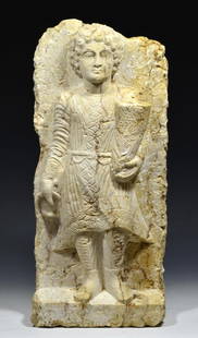 Superb Ancient  Roman Marble Relief of a Standing Youth: Palmyrene style Late 1st-3rd centuryâ€“AD. White limestone relief of a standing youth. Carved in high relief with a figure of a youth, he is standing on a ledge with his weight on his right leg,