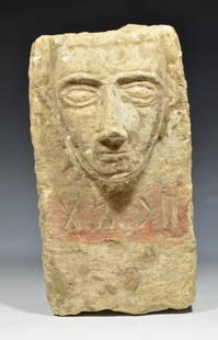 Ancient South Arabian Limestone Stele: South Arabia ca. 200 AD. Rectangular in form, sculpted at the end with the head of a man in the relief. His bearless spade-shaped face with arching brows, a long rectangular nose, and thin closed