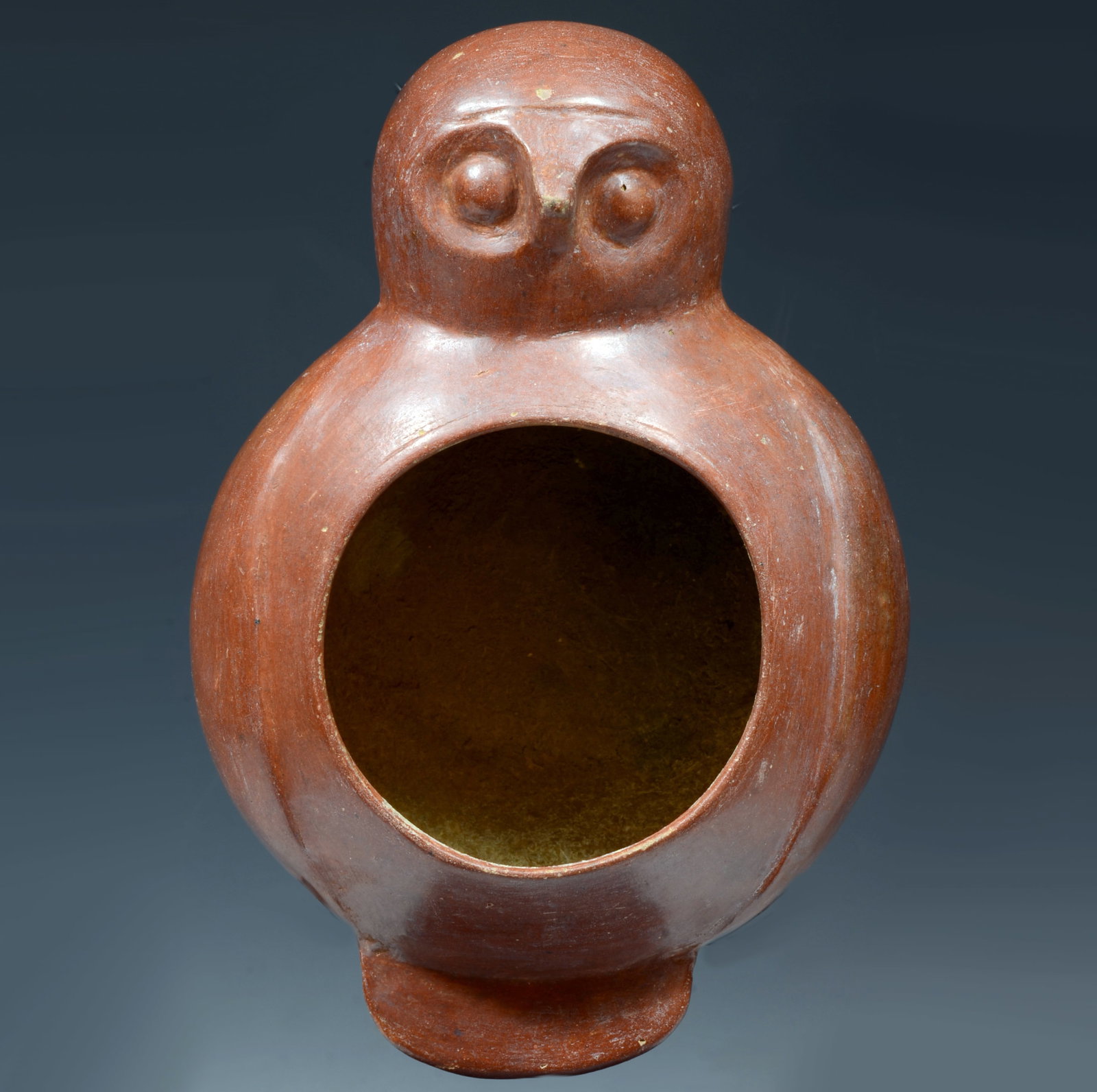 Pre-Columbian Chorrera Effigy Owl Vessel: Ecuador, Ca. 800 to 500 BC. A rounded smooth burnished ceremonial bowl with circular rim. Protruding along the side is the bird head opposite the tail. Nice red pigment and earth deposits. 14964. Size