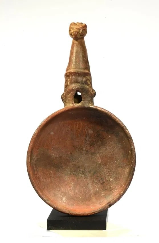 Costa Rican Pottery Ritual Vessel: Greater Nicoya, Period V Ca. 500-800 AD. A wide shallow vessel with handle in the form of a bird. With one rattle balls inside. Size: diam 4 1/2 in; H 9 in. +custom mount. Provenance: Ex collection of