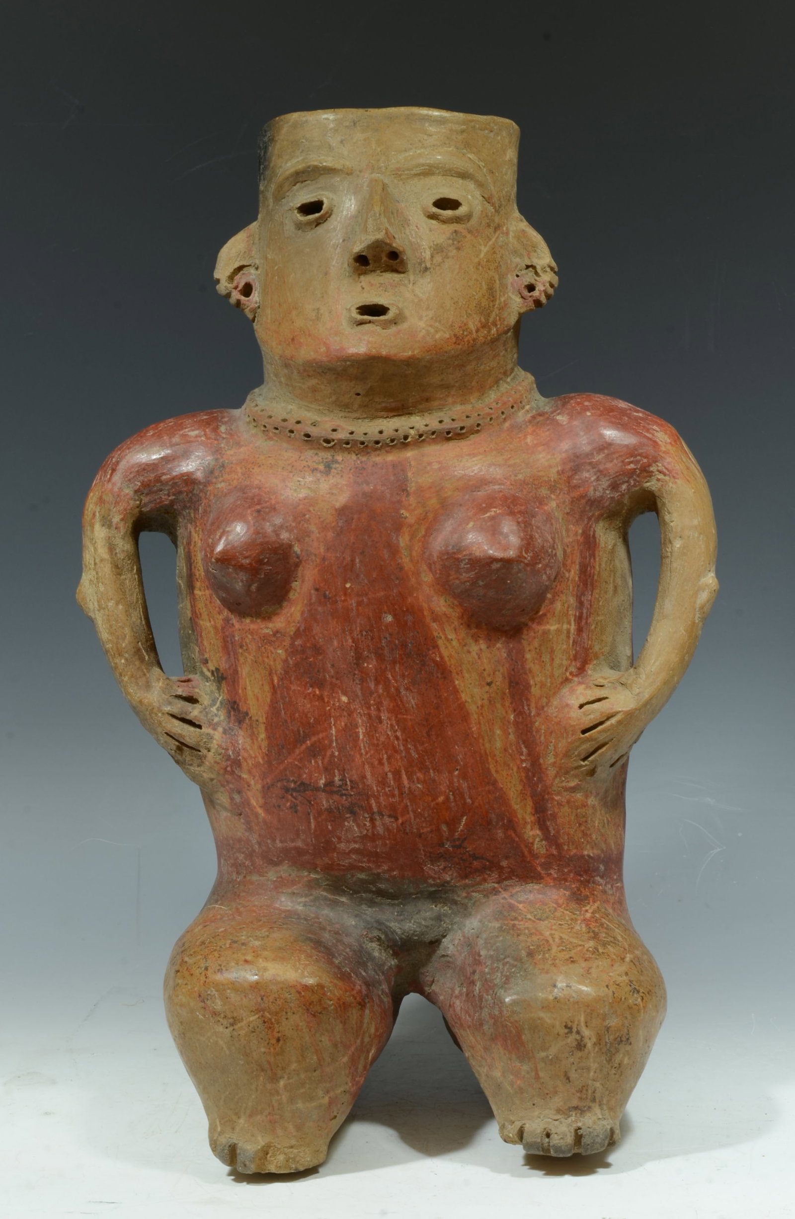 Zacatecas Painted Pottery Seated Female: West Mexico, Protoclassic, ca. 100 B.C. - A.D. 250. A plump gal seated with hands to the side and black and red geometric decoration. The abstract stylized body with rounded boobs, slender cylindrical