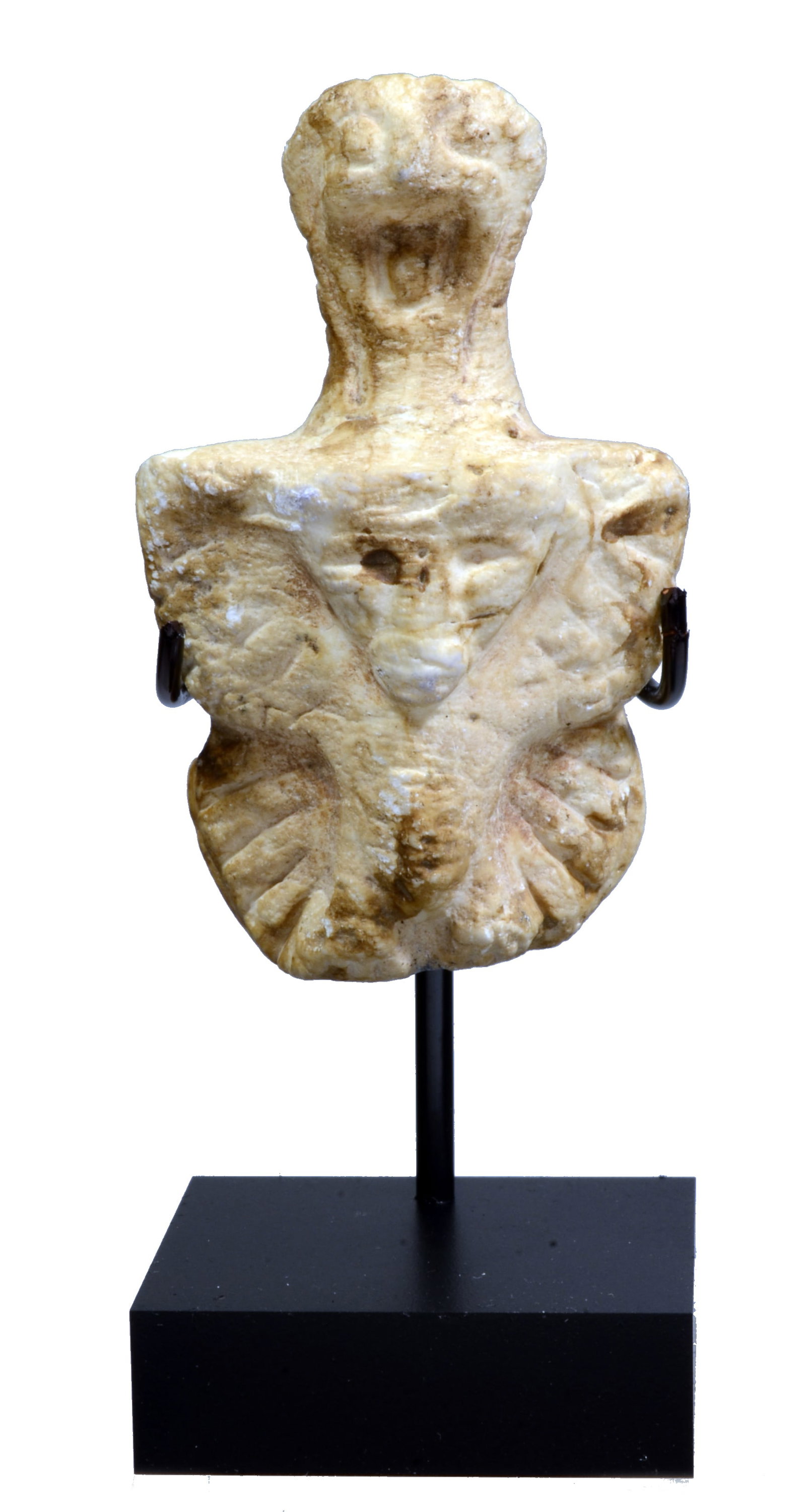Near Eastern Calcite Aegis of a Demon God: Neolithic Period, Circa 4000 to 2000 BCPerhaps an early form of Pazuzu, the demon god whose popular depiction we see in early cultures from this area. A schematic flat figure of violin shape; pronounc