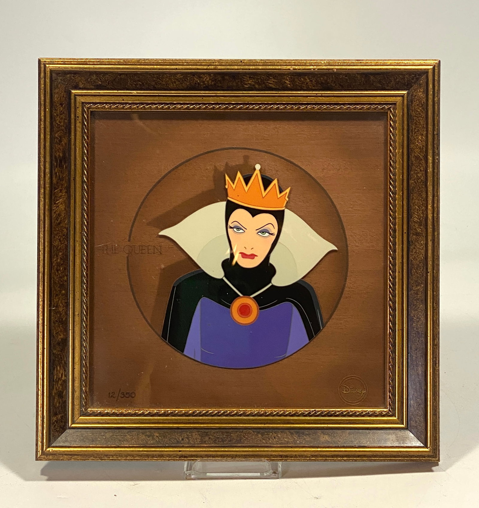 Disney, 'Snow White - The Queen Grimhilde' Limited Edition Courvoisier: Studio: Walt Disney. Title: 'The Queen' from Snow White and the Seven Dwarfs. Medium: hand-painted and hand-inked with a wood veneer background. Date: 1997. Character: The Queen. Edition: #12 of 350. 