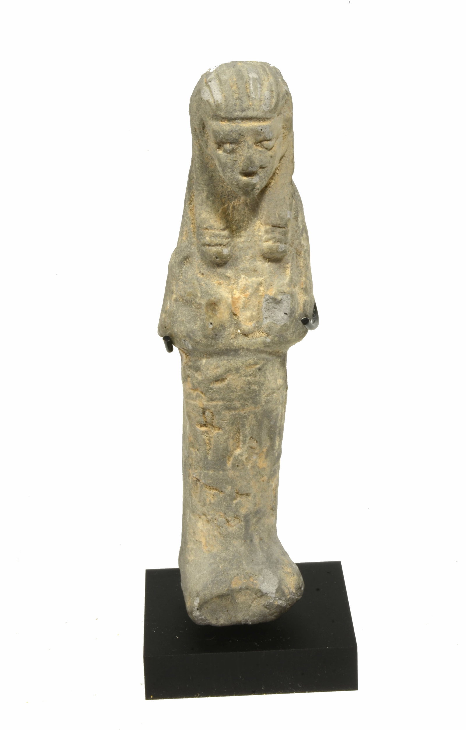 Egyptian Molded Pottery Ushabti: Style piece. A servant figure for the afterlife with hands folded across chest, long wig and one vertical line of hieroglyphic text down center. Size 5-1/4 inches + + base.Ex Harry Wallace Collection 