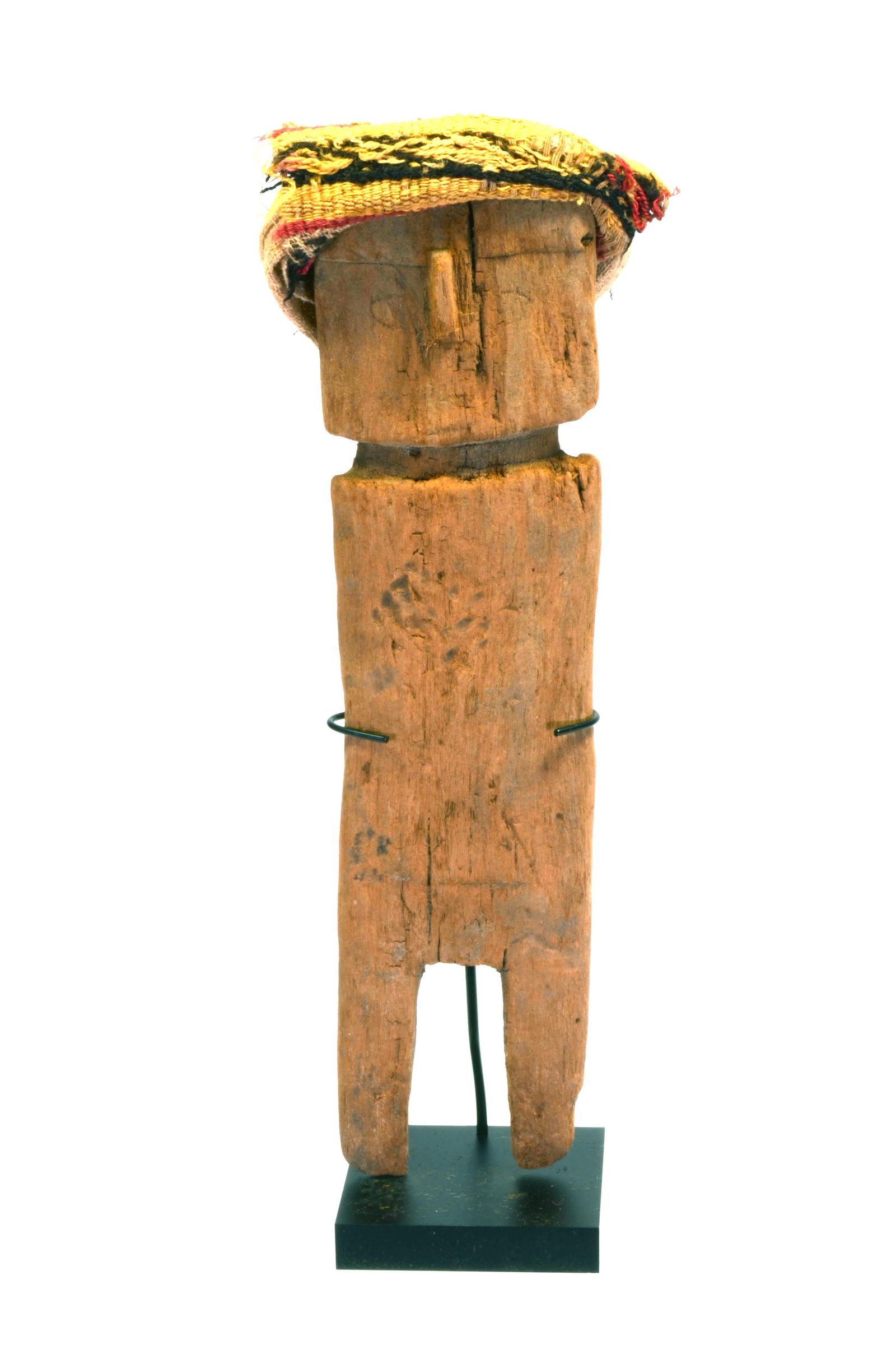 Chancay Wood Doll with Textile Headdress: Chancay Wood Doll with textile Headdress. North Coast, Ca. 900 to 1100 AD, Abstract carved wood rectangular form with delineated legs and protruding nose. Eyes lightly incised and wearing textile gauz