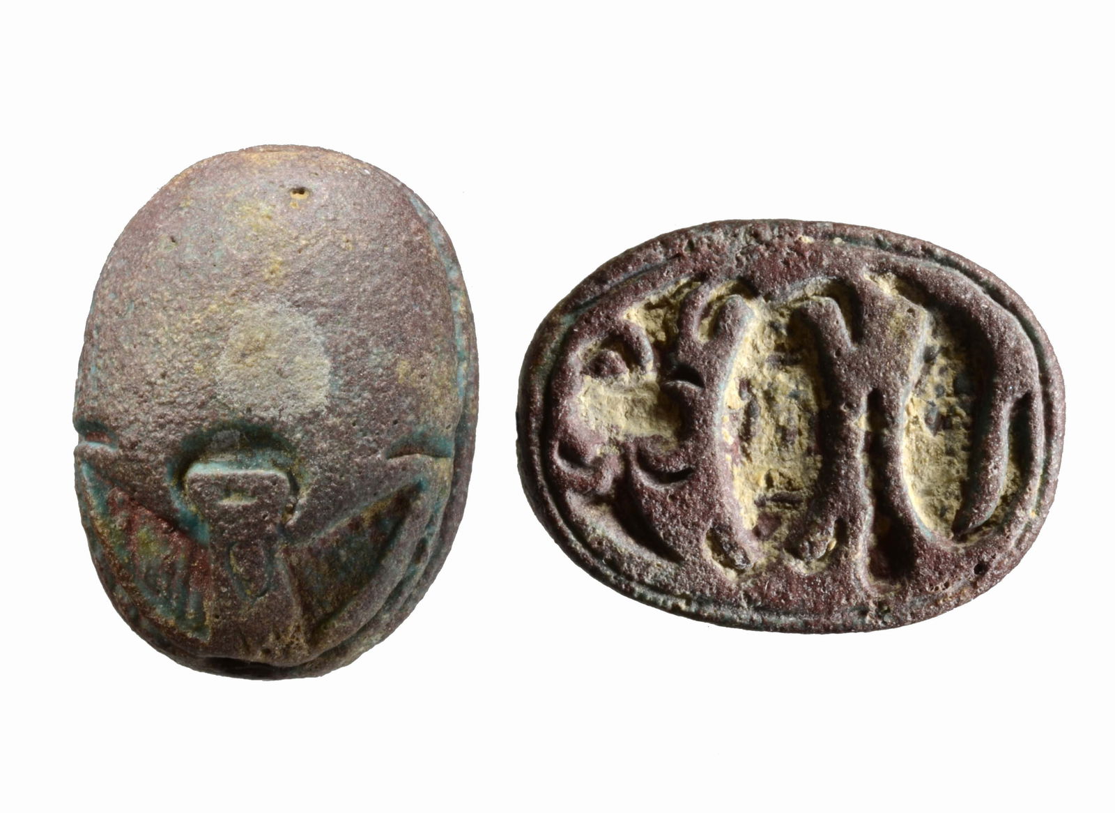 Egyptian Purple Glaze Faience Scarab for Protection: Dynasty XXII-XXVI Ca 945 to 525 BC.Naturalistic carved, smooth wing case; base inscribed with protective powers including the symbol of Neith, two intercepting arcs or two crossed arrows at the center