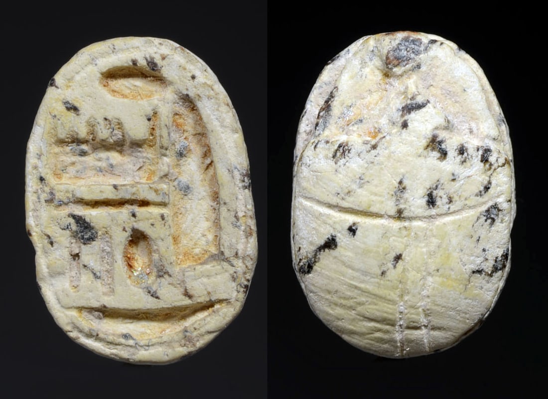 Ancient Egyptian White Steatite Scarab for God Amon: New Kingdom, Ca. 1550 BC. Naturalistic top; base inscribed with Amon Re The inscription is surrounded by a single line; pierced longitudinally for suspension. Size: (1.6 cm) L. small chip else intact.
