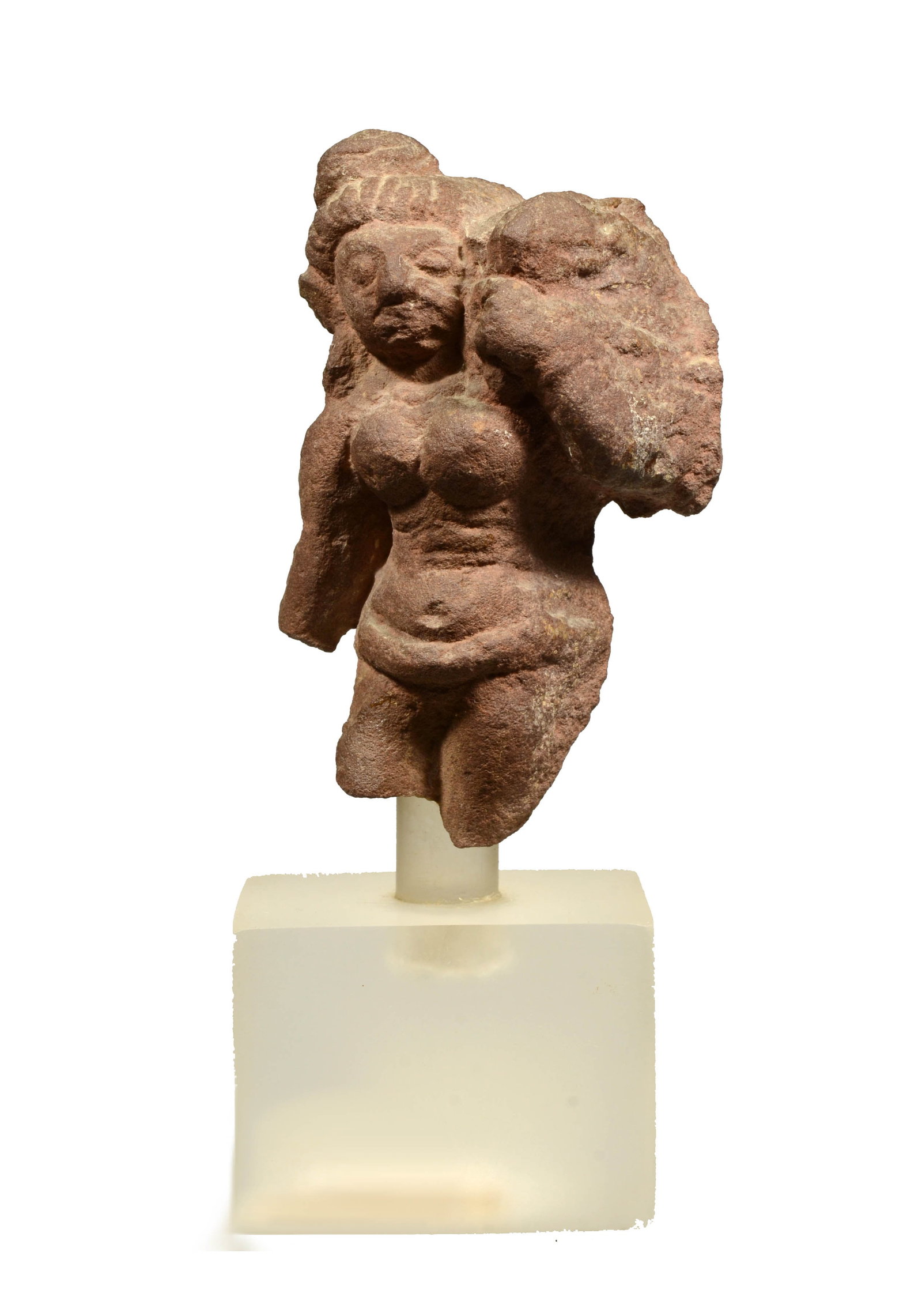 Small Medieval Indian Pink Sandstone Female Yakshi: Rajastan, Ca. 10th to 12th Century AD A fragmented depiction of the Goddess standing with her hips swung out, with her hair up in a chignon, she wearing a dhoti and has large rounded breasts.Size 4-5/