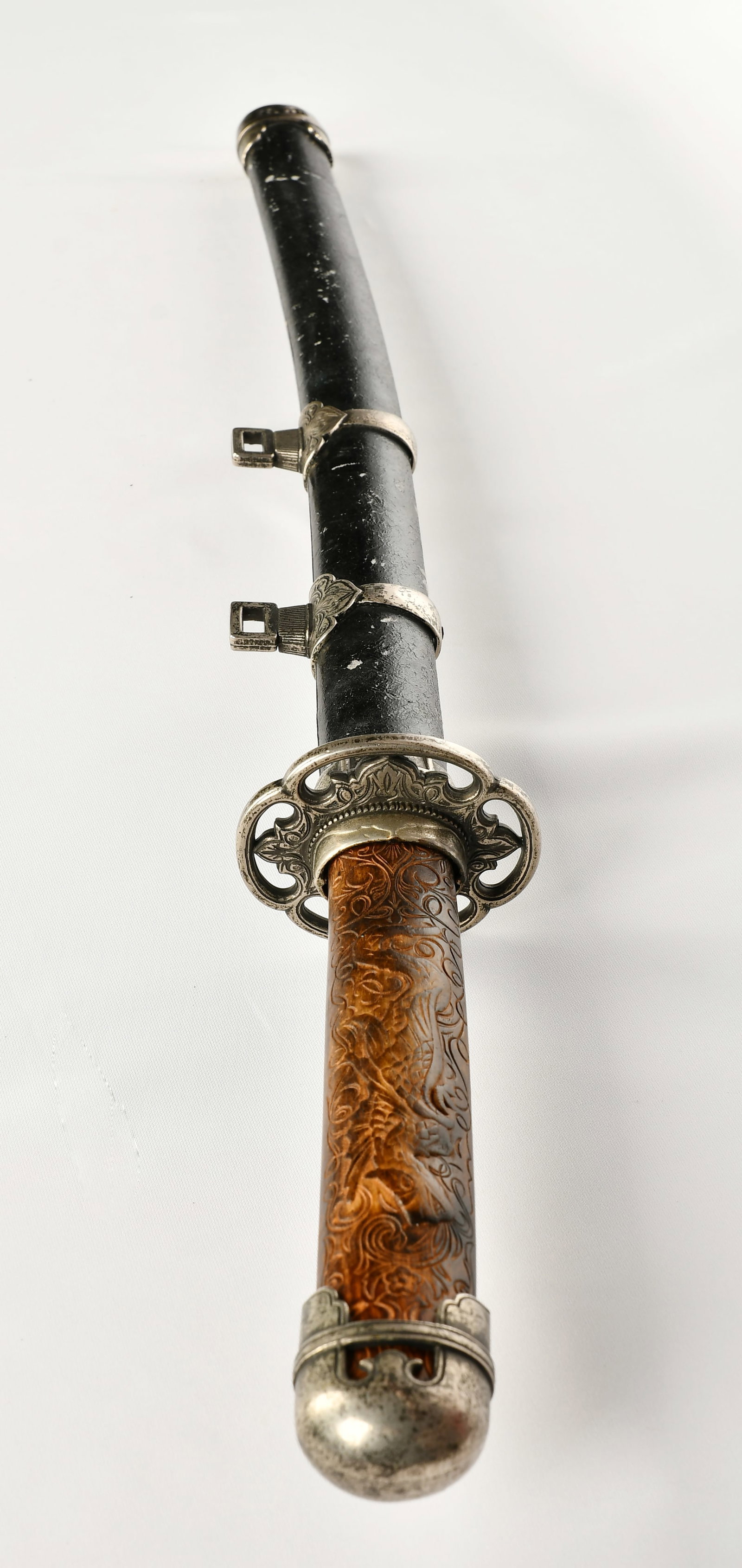 An Ancient Korean Sword: A Korean ceremonial sword,carved wooded hilt,has not been sharpened.silver fittings 19th C.,length:73cm