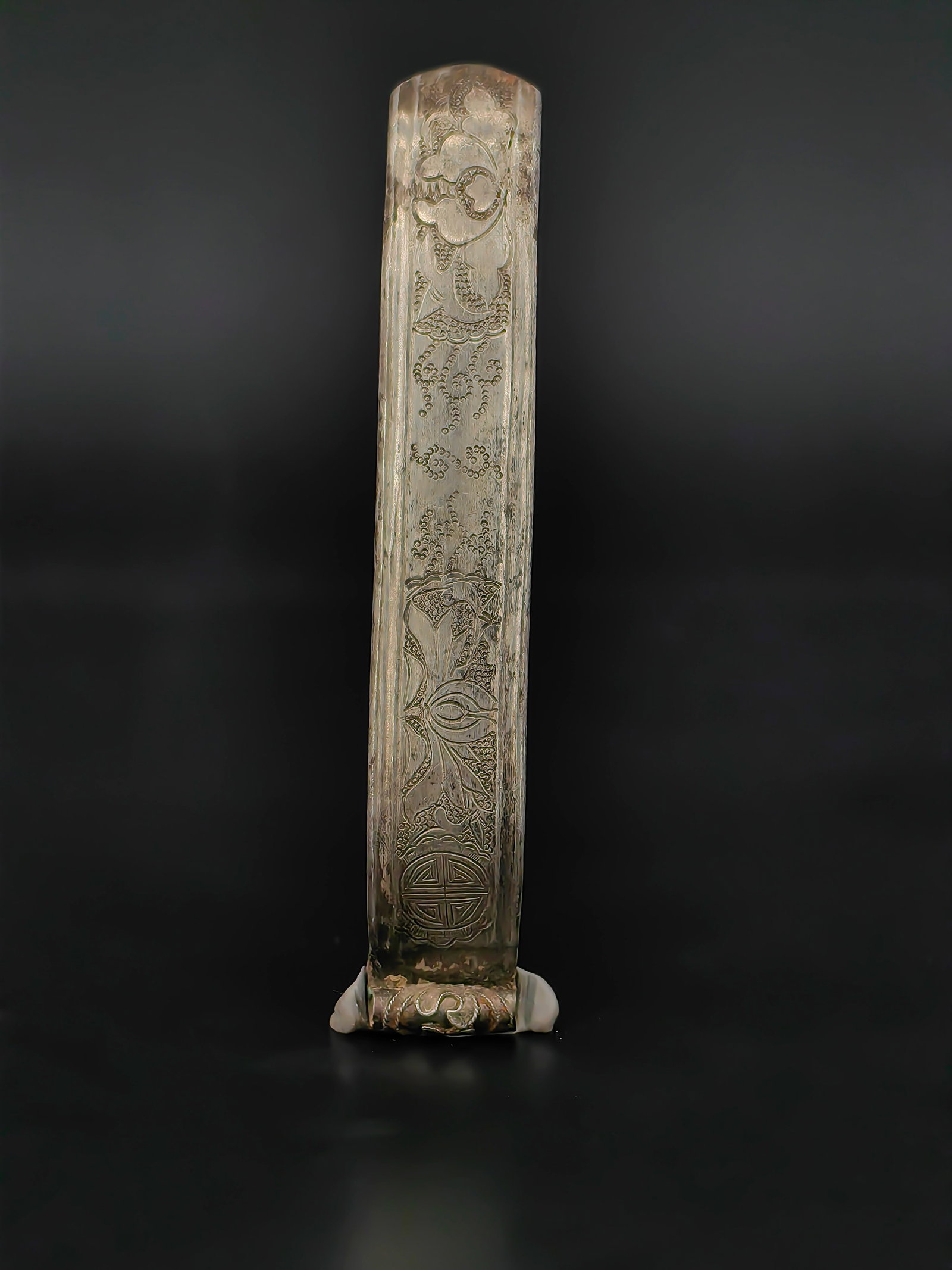 An Antique Chinese Book Lifter: Antique Chinese brass scholar’s book page lifter,Qing Dynasty. The gently curved body is finely engraved with auspicious motifs including stylized floral scrolls, a longevity medallion, and