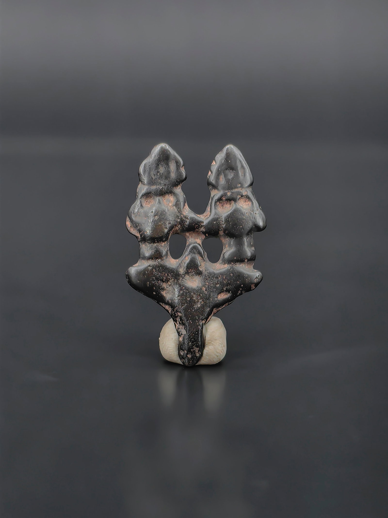 An Antique Qing Dynasty Hole Cover: Antique Chinese cast iron openwork ornament or hole cover, Qing Dynasty. The small piece is cast in an abstract form resembling a traditional scholar’s rock, with naturalistic contours and pierced o