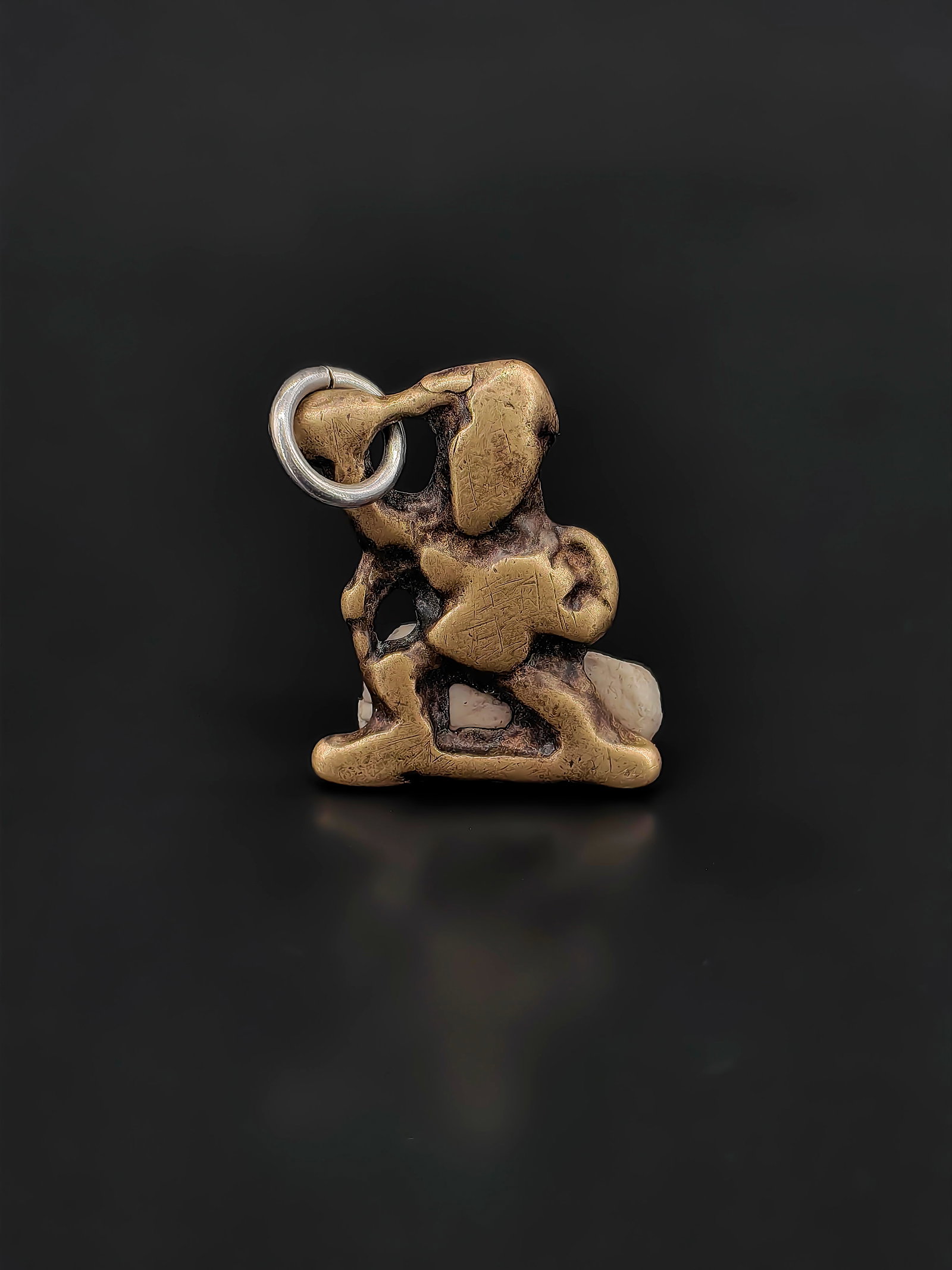 An Antique Brass Openwork Pendant: Antique Chinese cast brass openwork pendant, Qing Dynasty.Measuring approximately 3 cm in height and weighing about 5 grams