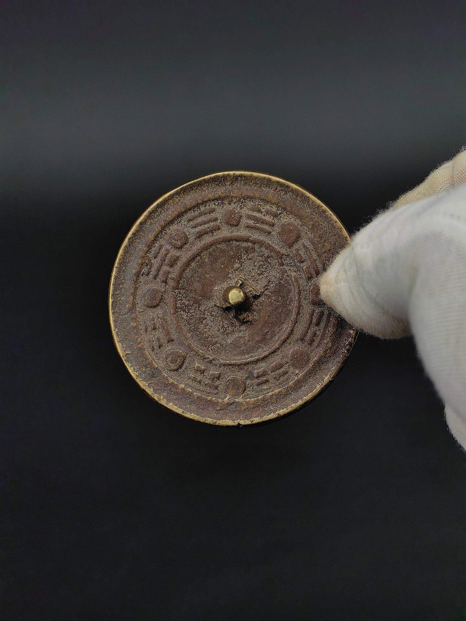 A Qing Dynasty Bronze Mirror: This is a Bronze Mirror with Eight Trigrams (Bagua) pattern. The circular mirror features a central knob surrounded by the traditional Eight Trigrams symbols, representing protection and good