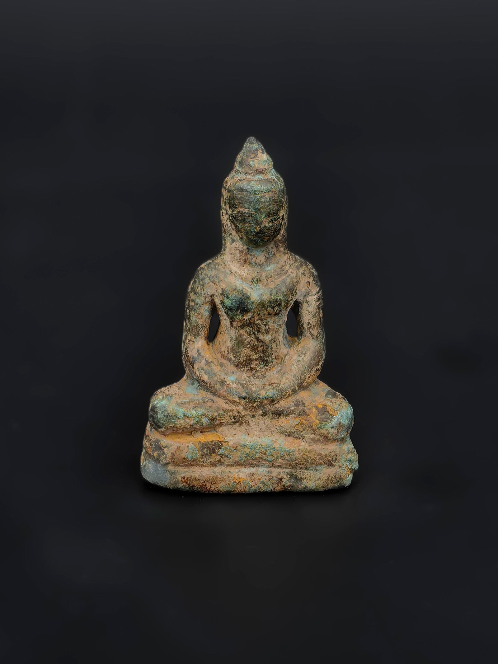 A Small Bronze Seated Buddha, Ming to Early Qing Dynasty: This miniature Buddha stands approximately 5 cm tall. The figure is depicted in a meditative seated posture with harmonious proportions and a serene countenance. Despite its petite size, the casting i