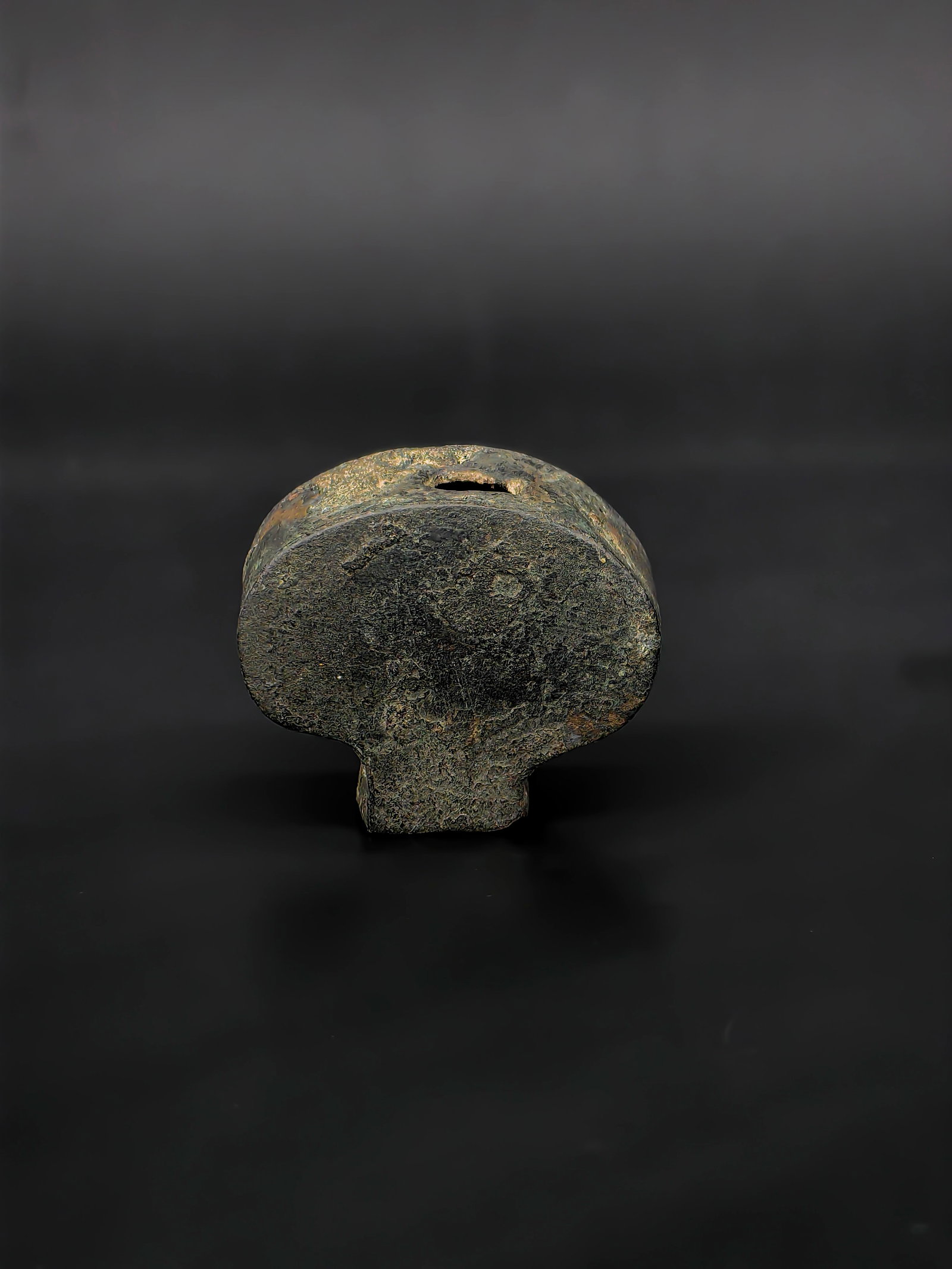A Chinese Qing Dynasty Sword Pommel: This lot is a classic sword pommel from the Qing Dynasty. Shaped in a dignified Ruyi-cloud (or mushroom) silhouette, the piece carries a substantial and archaic aesthetic. The surface is enveloped in