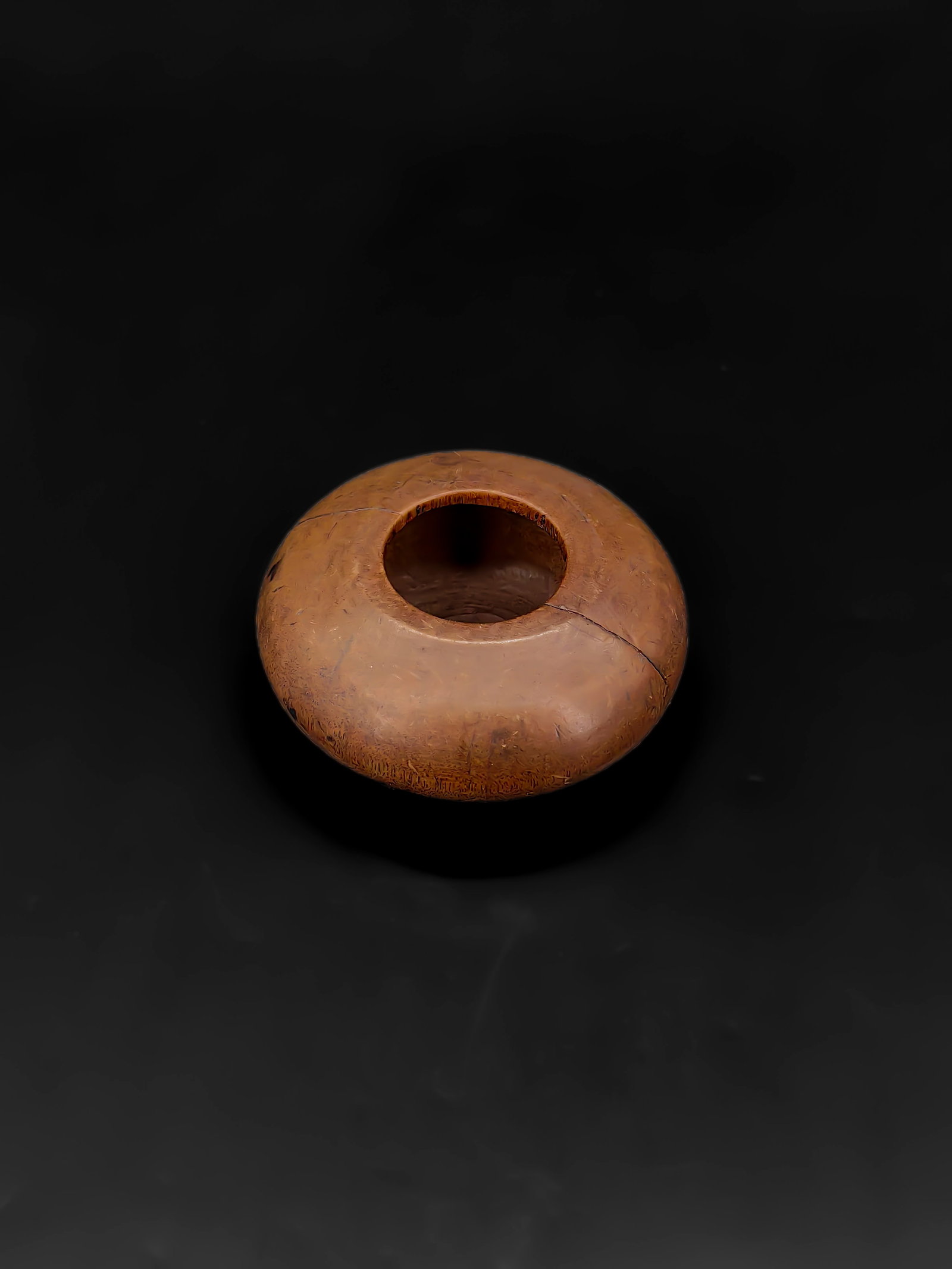 A Qing Dynasty Boxwood Water Coupe: This is a boxwood water coupe from the Qing Dynasty. It features a compressed globular body with a constricted mouth and a flat base, measuring approximately 6 cm in diameter. The exterior is