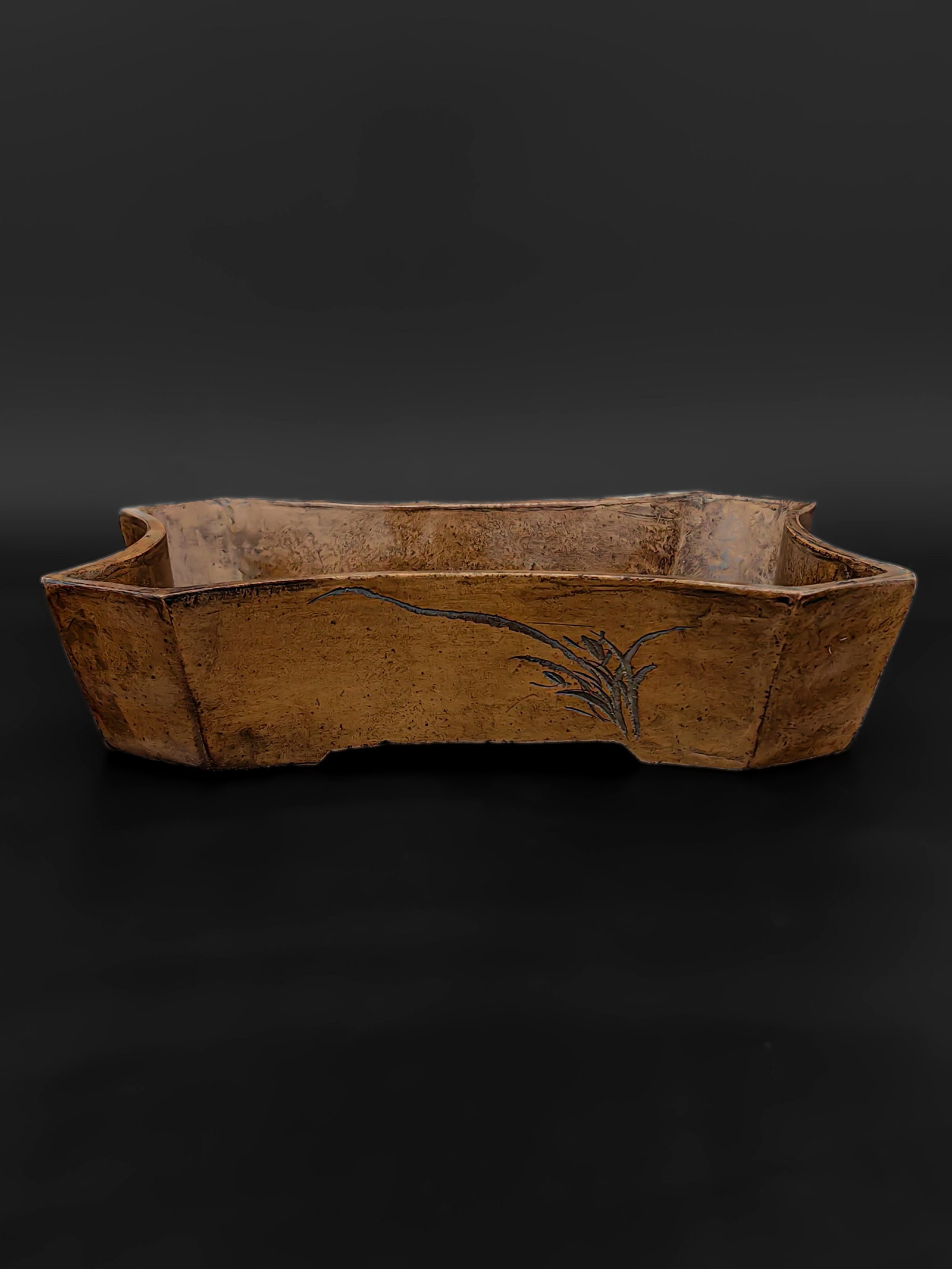 An Antique ZiSha Planter, Republic Period: This artifact is a uniquely shaped bronze scholar’s water coupe or planter, featuring a begonia form. One side is inscribed with a fluid running-script line, alongside a circular seal. The reverse s