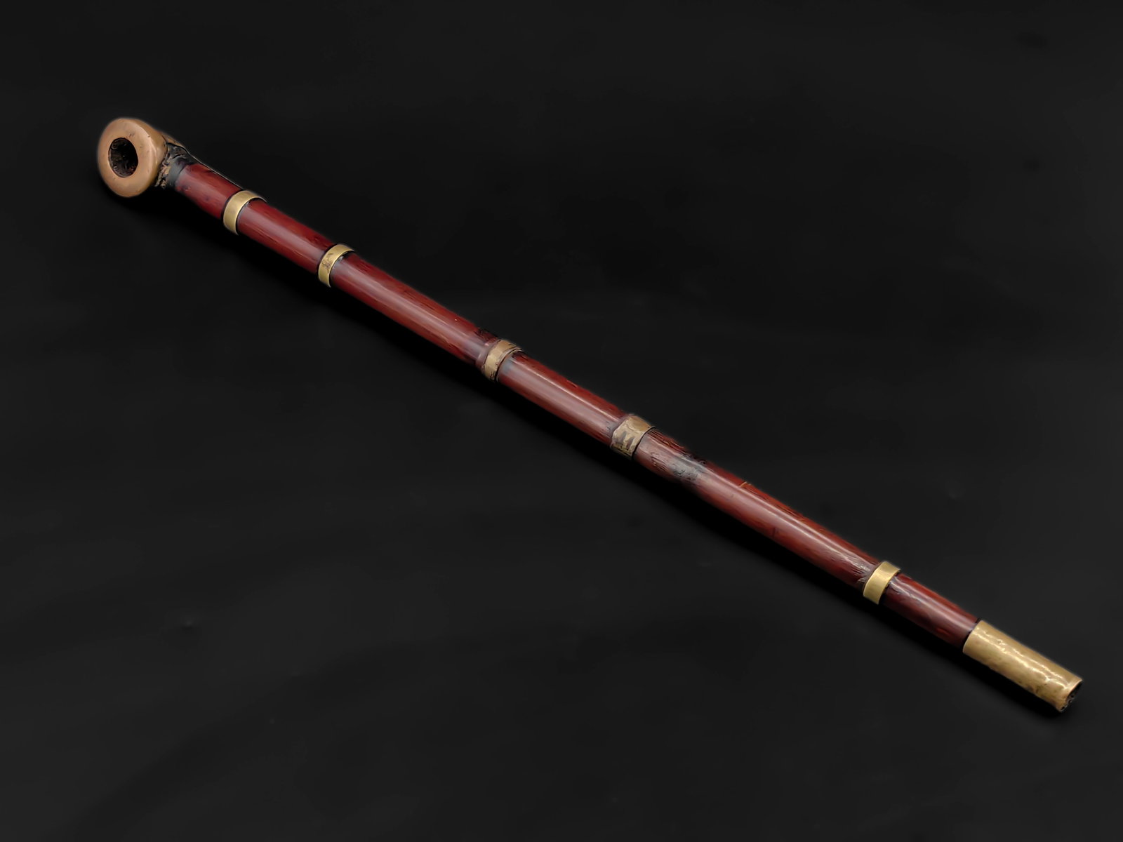 An Antique Chinese Tobacco Pipe,Republic Perioc: This is a traditional Chinese tobacco pipe, consisting of a bamboo stem, brass mouthpiece and bowl, measuring approximately 35 cm in length. Copper bands reinforce the bamboo joints, while the warm