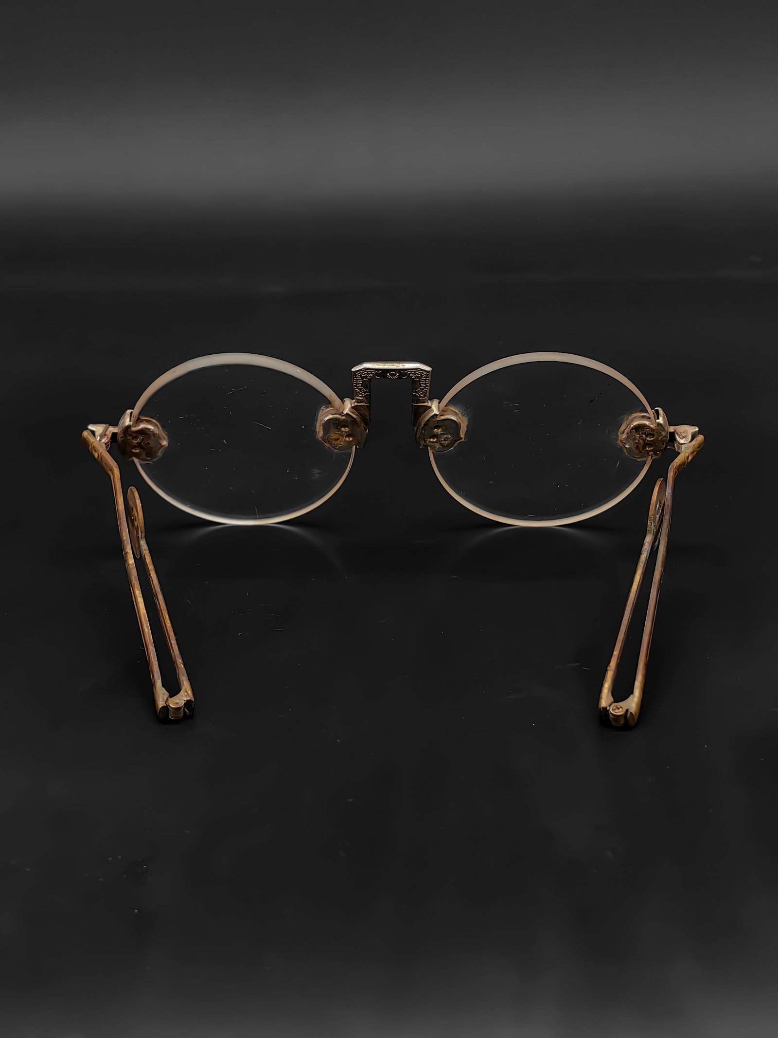 An Antique Pair of Chinese Folding Sunglasses: This is an antique pair of Chinese folding sunglasses, measuring approximately 14.5 cm in width. The round lenses are meticulously crafted from natural smoky quartz (tea crystal). The brass frame exhi