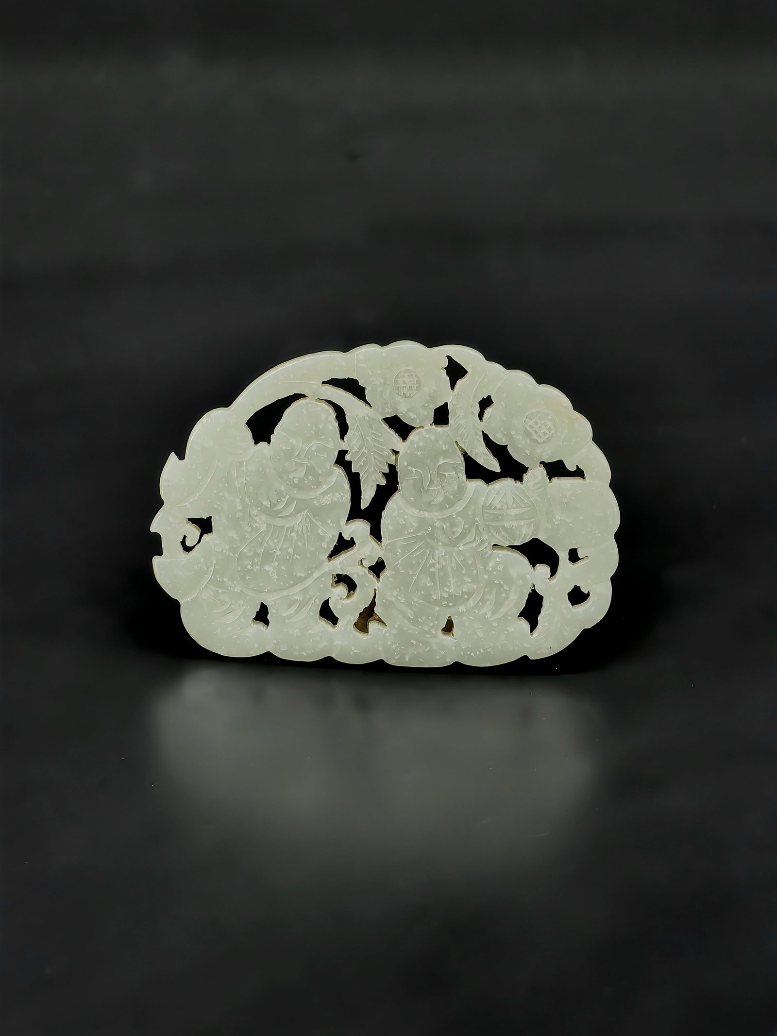 An Antique Qing Dynasty Jade Plaque: This is a fine Qing Dynasty openwork white jade plaque featuring boys and auspicious flowers. The jade exhibits a warm, translucent quality with a subtle, aged patina. Utilizing the layered pierced ca