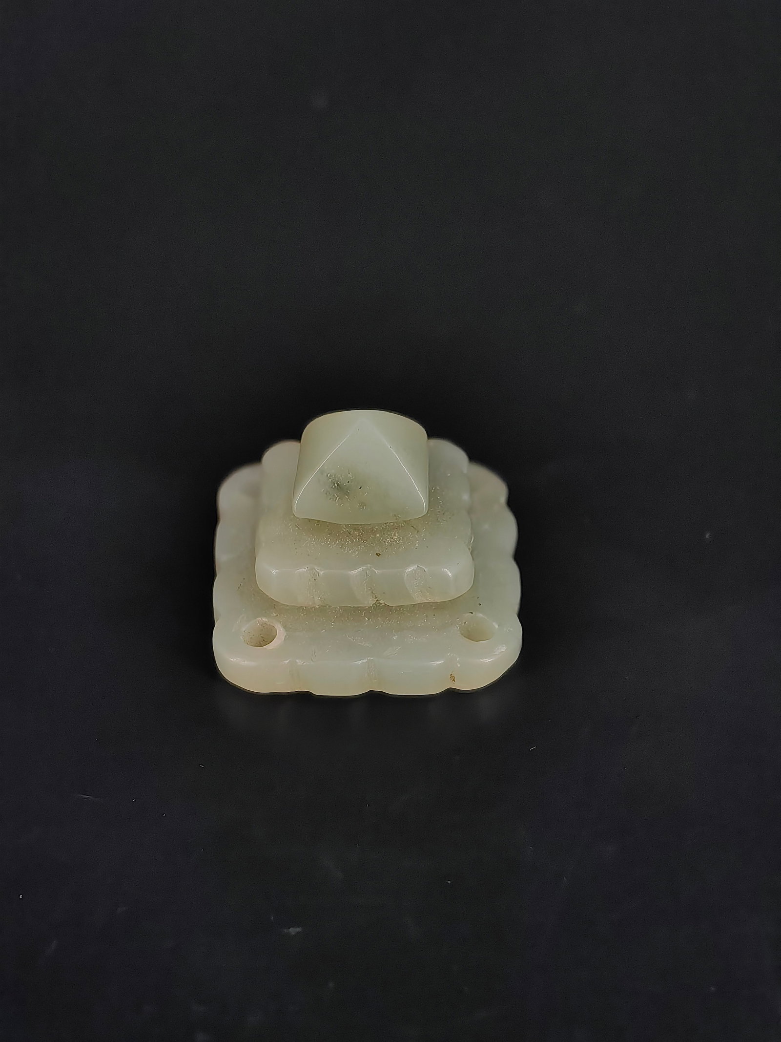 An Ancient Jade Ornament: This item features a Ming or Qing dynasty style greenish-white jade tiered pagoda-shaped ornament. The piece is carved into a multi-layered platform, topped with a pyramidal finial. The lower tiers