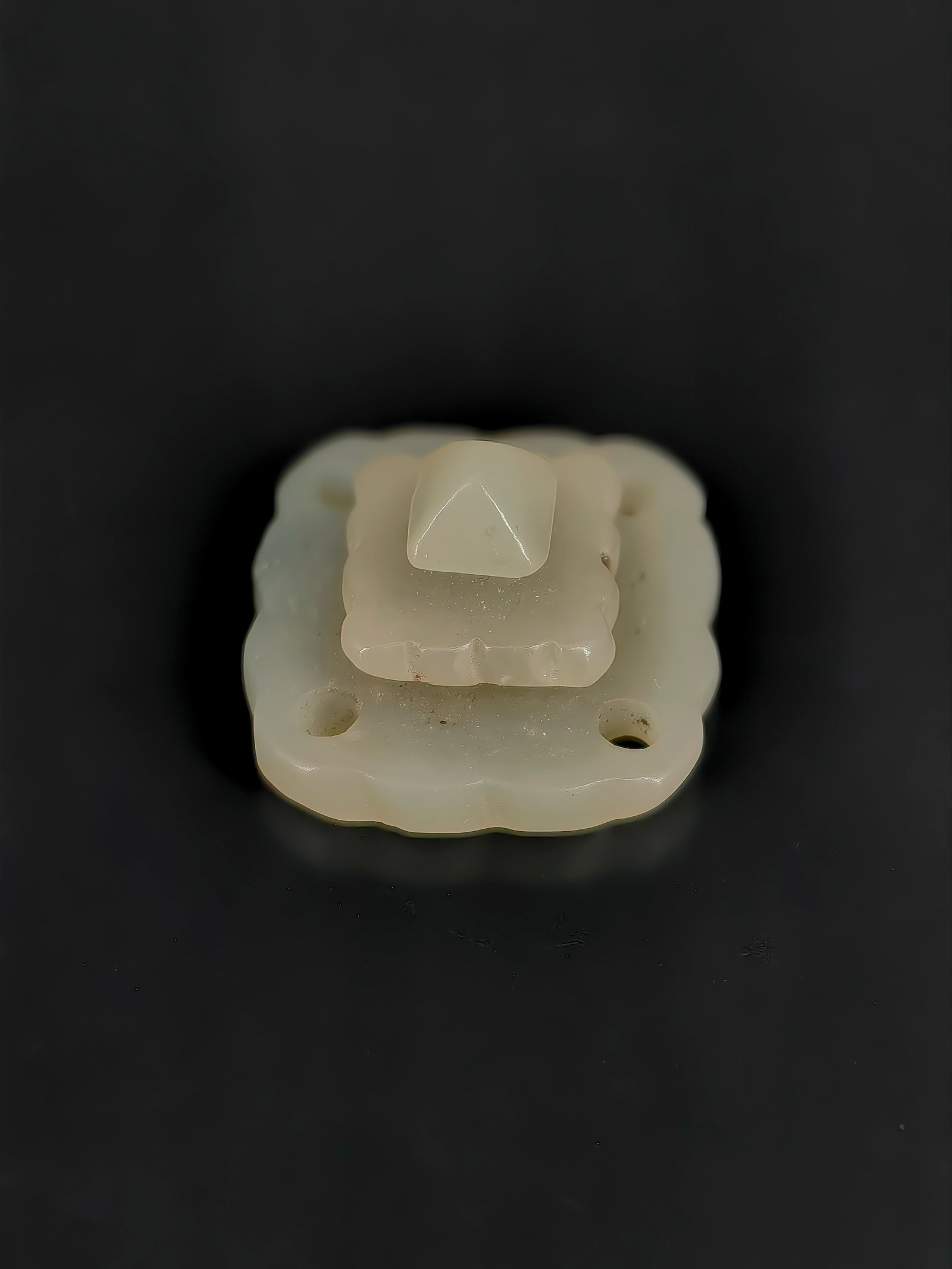 An Antique Jade Hat Ornament: This antique item is a Ming or Qing dynasty style tiered greenish-white jade hat ornament (applique). Structurally designed as a square, three-layered stepped platform, it features a smooth, unadorned