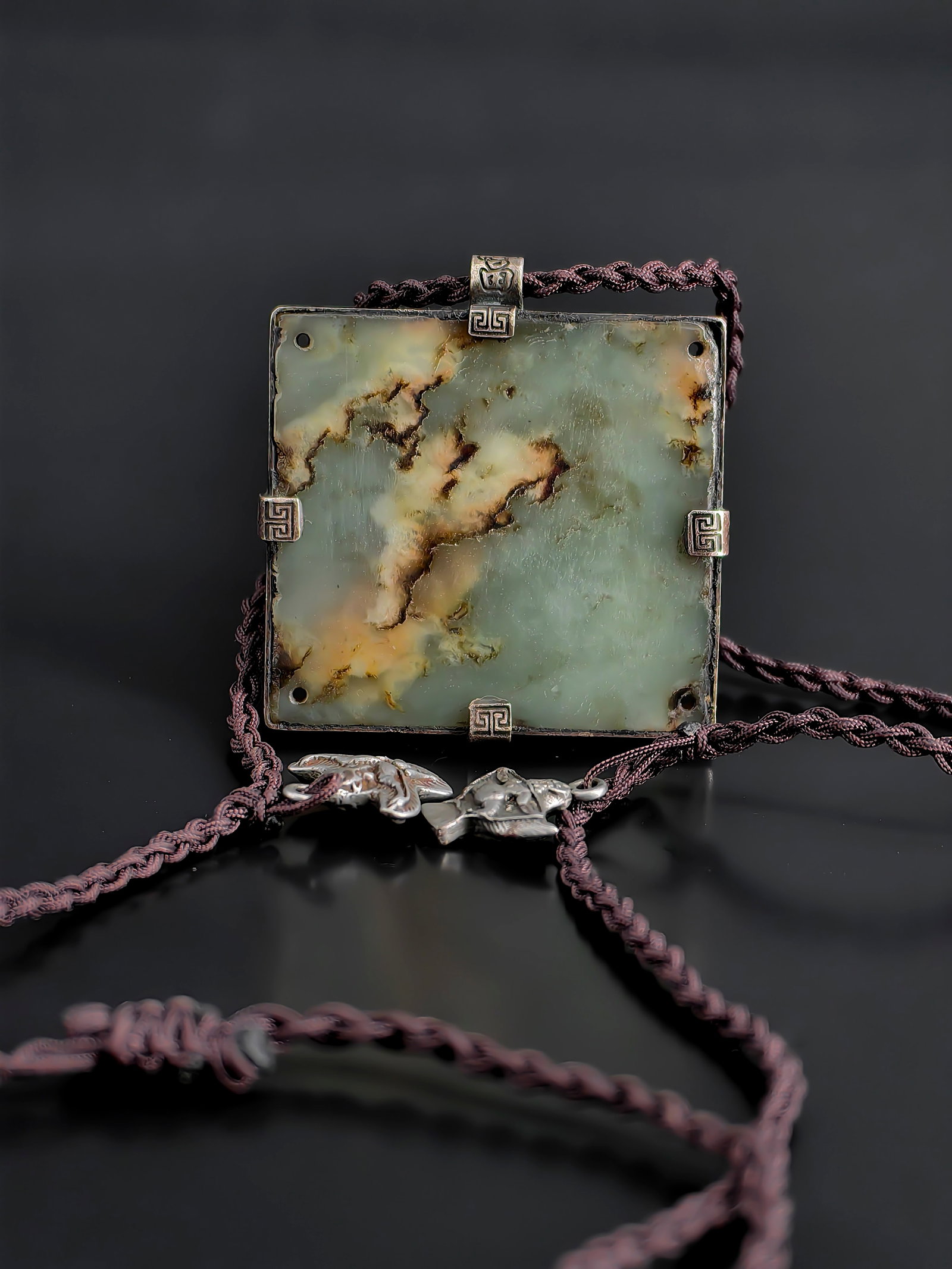 An Antique Square Jade Pendant: This Qing Dynasty antique jade pendant features a square plaque delicately carved with a foreign musician ("Hu ren"). The front utilizes a refined low-relief carving to capture a seated foreign
